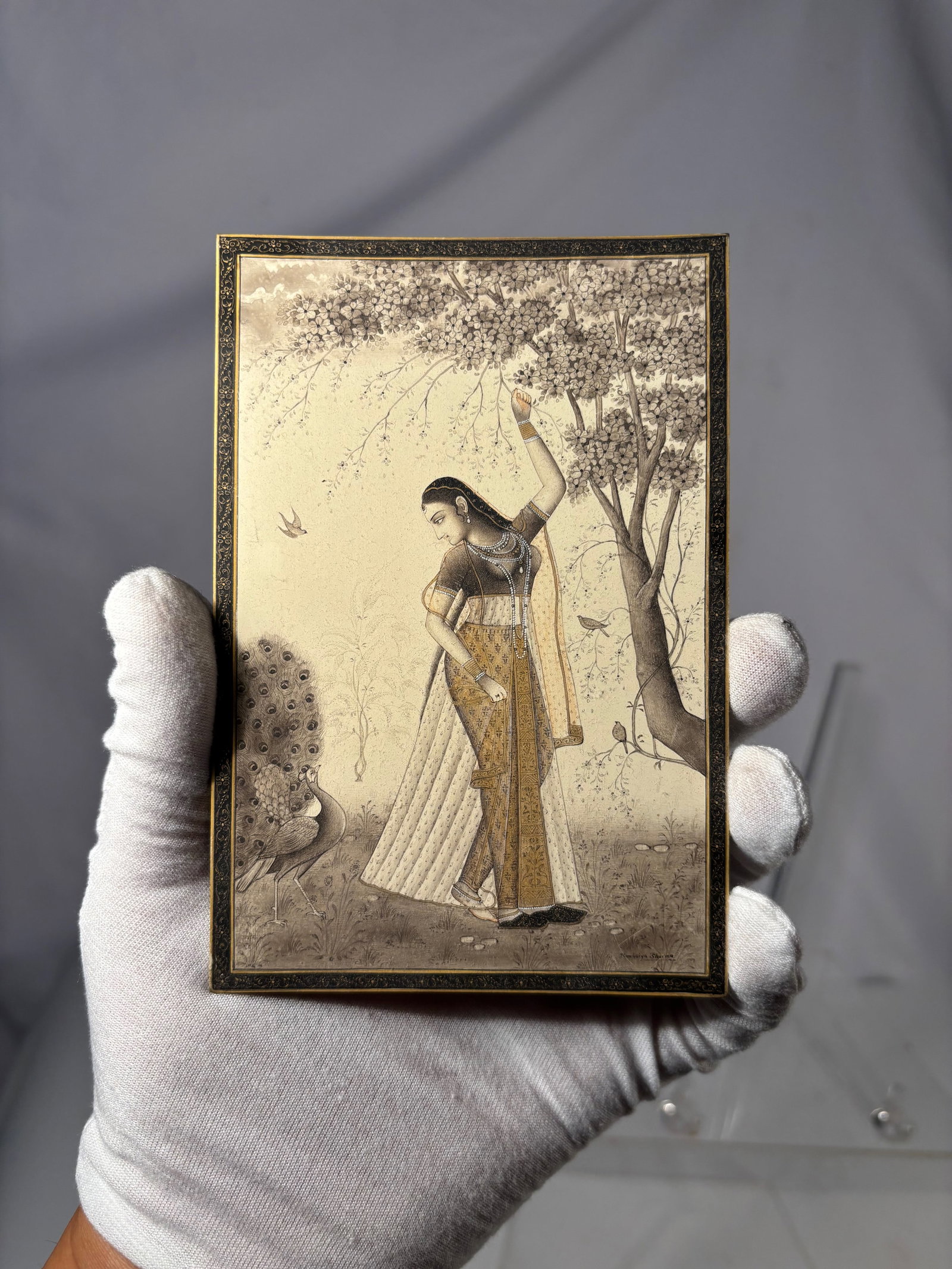 Indian Lady Under a Tree Miniature Painting, Hand-Painted,: Fine hand-painted Indian miniature showing a Nayika (lady) beneath a flowering tree, rendered in a soft monochrome palette with gold accents and delicate line work. Executed in opaque watercolor on a