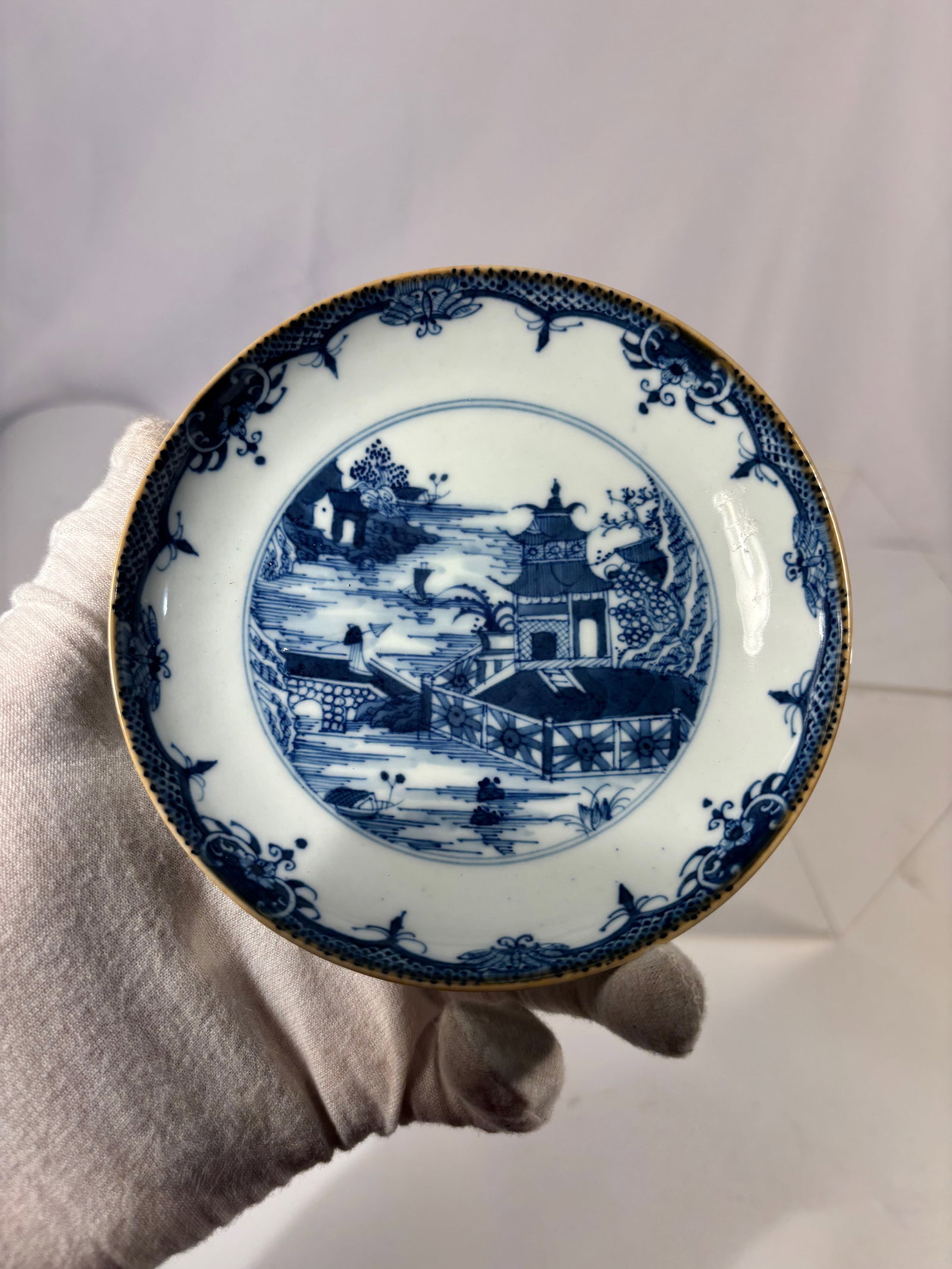 A Chinese Blue and White Porcelain Dish, Qianlong Period (1736–1795): Qianlong period (1736–1795); A finely potted Chinese blue and white porcelain dish, Qianlong period (1736–1795), decorated in underglaze cobalt blue with a riverside landscape scene depicting pavi