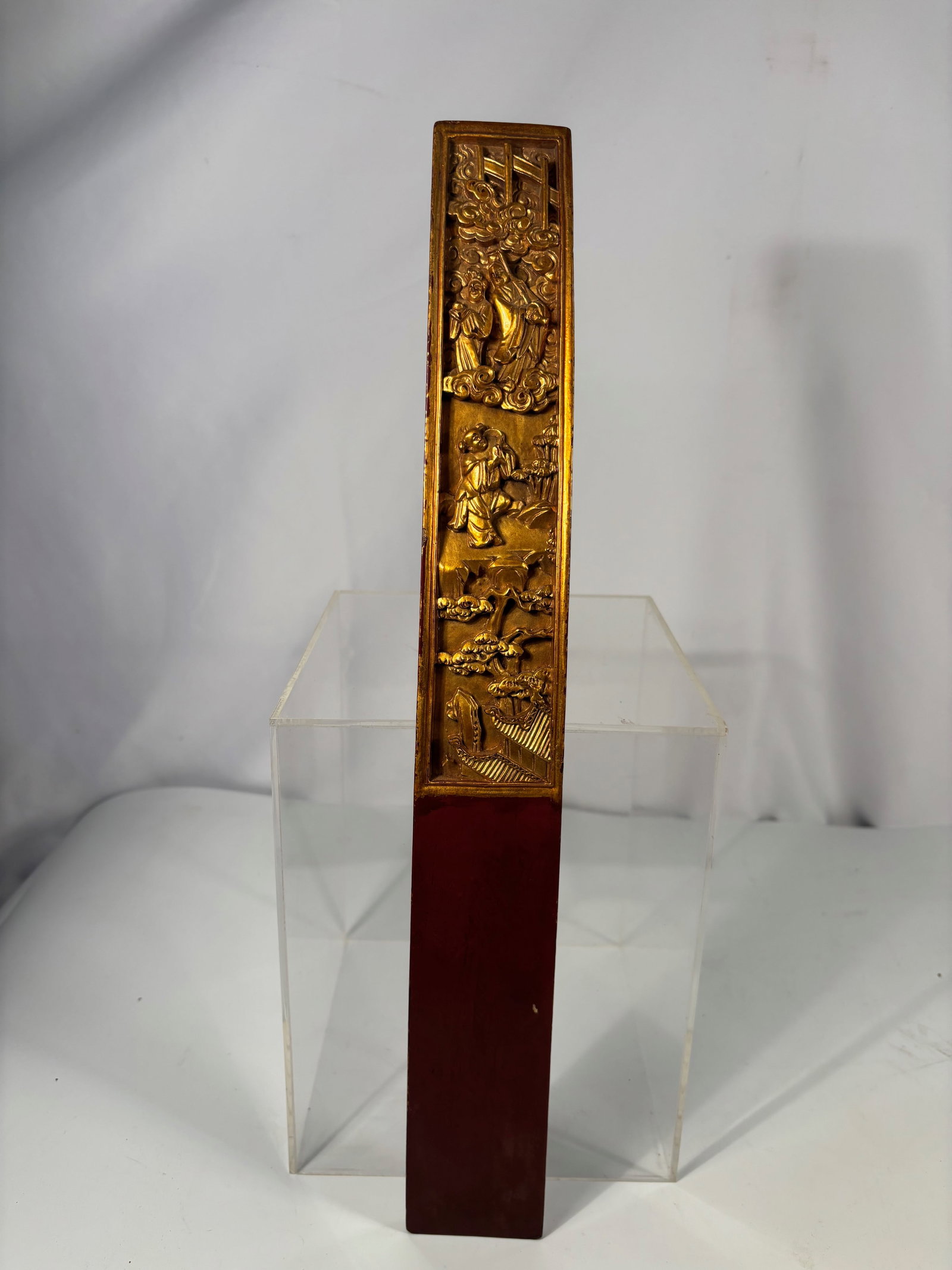 A Chinese Gilt and Lacquered Wooden Court Tablet (Hu Board): Qing dynasty(1644-1912); A finely carved and gilt-lacquered wooden Hu board (court tablet), depicting figures among swirling clouds and a pavilion scene, symbolizing virtue and official dignity. The s