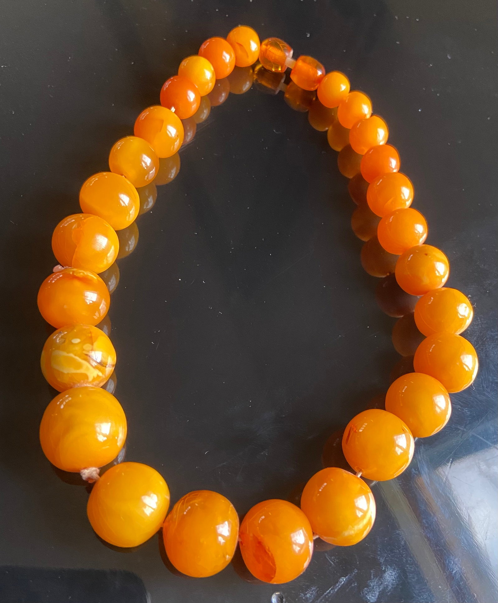 A Butterscotch eggyolk amber round beads necklace 61gram: Opaque Quality: It is more translucent, butterscotch amber tends to have a creamy, opaque texture.Dimensions?Length: 17 inches; Total weight: 61g; Largest beads size: 30mm;