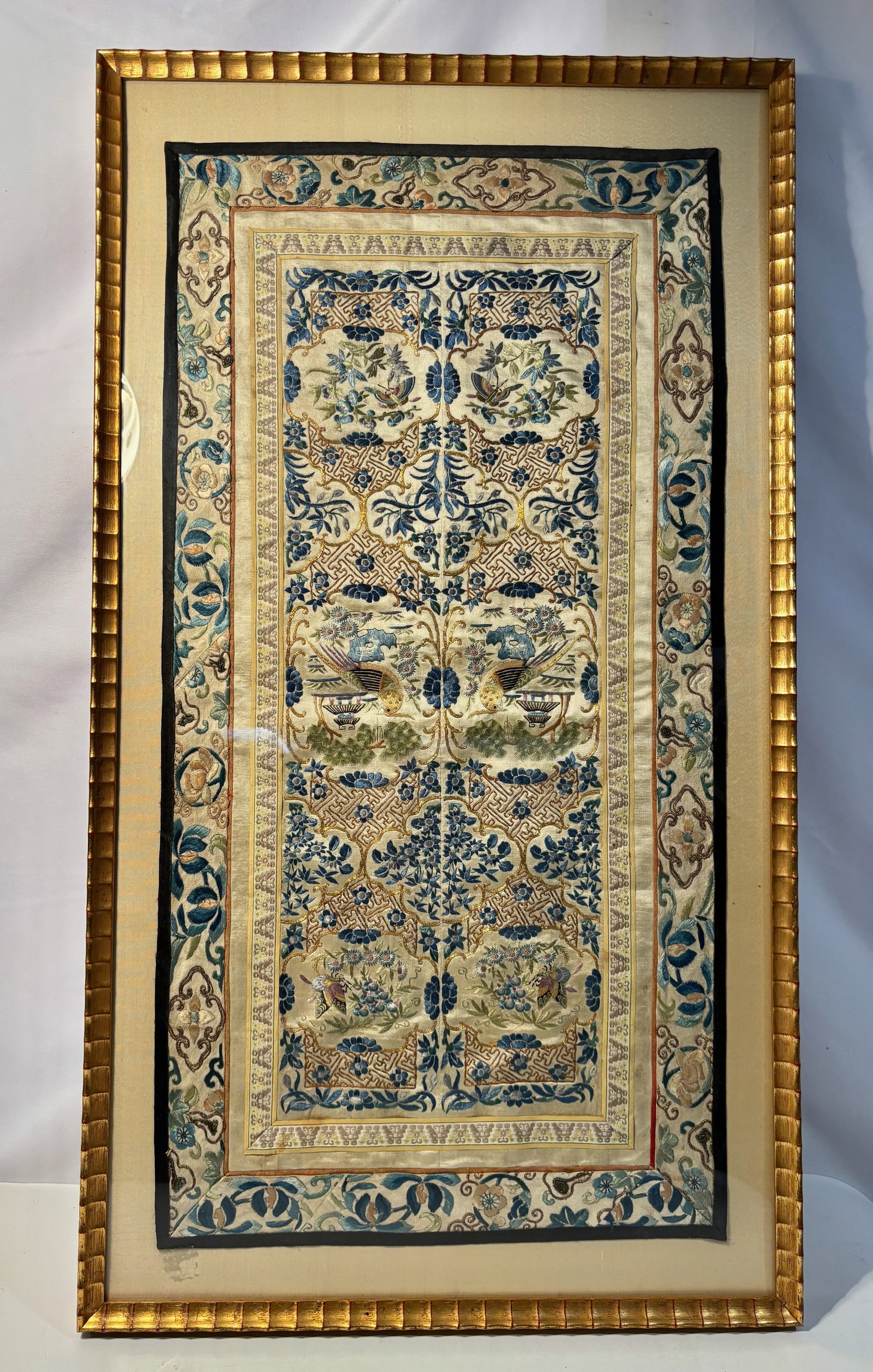 A Chinese Hand-Embroidered Silk Panel with Birds, Framed: Qing Dnasty(1644-1912), Chinese silk embroidery panel, finely hand-embroidered with a symmetrical arrangement of birds amid scrolling floral and foliate motifs, executed in shades of blue, green, and