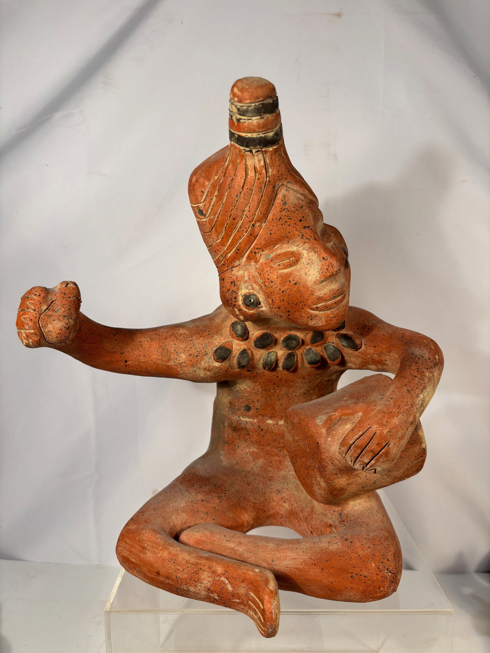 Pre-Columbian Style Nayarit Seated Figure, West Mexico: A polychrome ceramic figure in the West Mexico / Nayarit style, depicted standing with painted geometric body decoration and wearing a coiled headdress. The figure shows traditional regional features