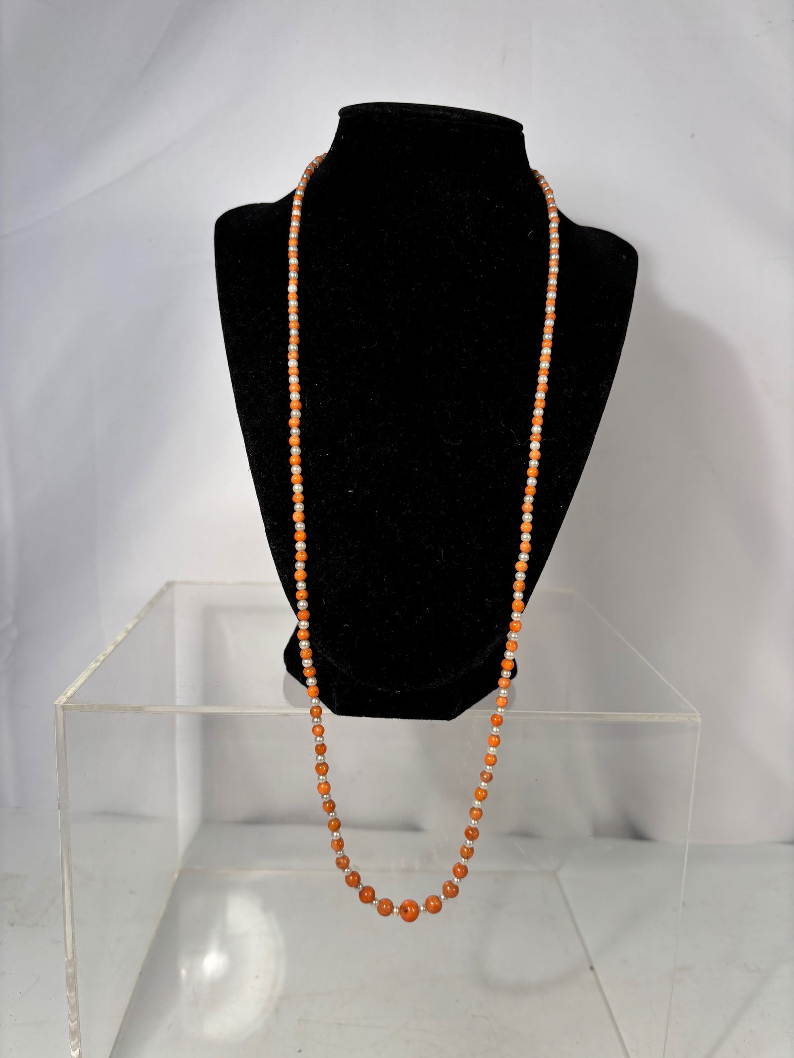 A long Victorian Coral & Seed Pearl Necklace with 14K Gold Clasp: A beautiful Victorian coral and seed pearl necklace, featuring hand-strung round salmon-colored natural coral beads alternating with small white seed pearls. The strand is finished with a secure 14K g