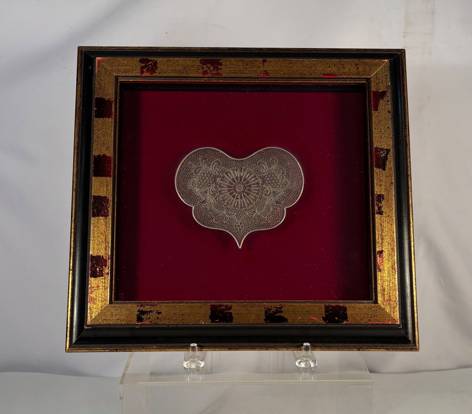 A European Silver Filigree Ornament , Framed: Antique European silver filigree ornament of stylized cloud or heart form, intricately worked with delicate wire filigree featuring a central floral rosette and scrolling motifs. Likely late 19th to e