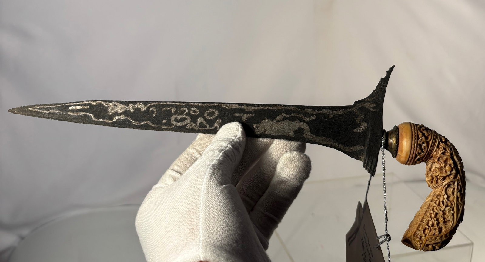 Sumbawa Indonesian Kris (Keris) Dagger with Pamor Blade and Carved Bone Hilt, Late 19th–Early 20th: An Indonesian kris (keris) dagger from Sumbawa, featuring a straight (lurus) pamor-forged blade with natural nickel–iron patterning. The blade exhibits traditional darkened patina with visible pamor