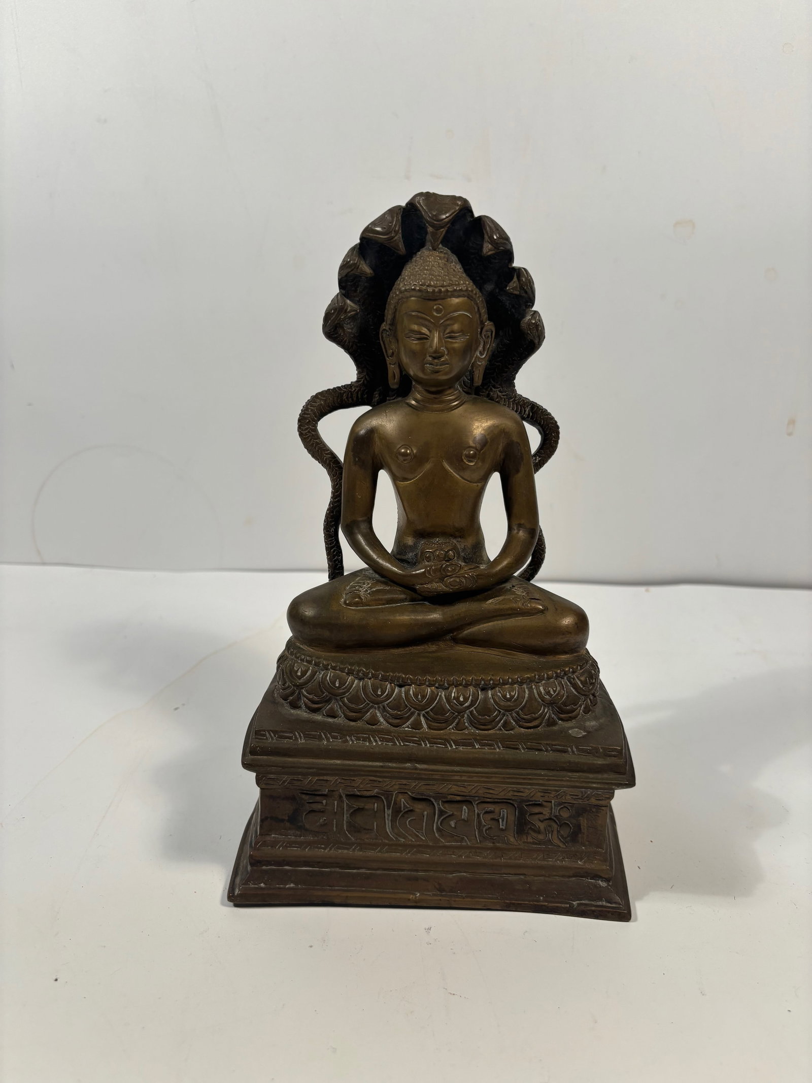 A bronze statue of the Buddha sheltered by the Naga (serpent) Mucalinda (1 of 12)