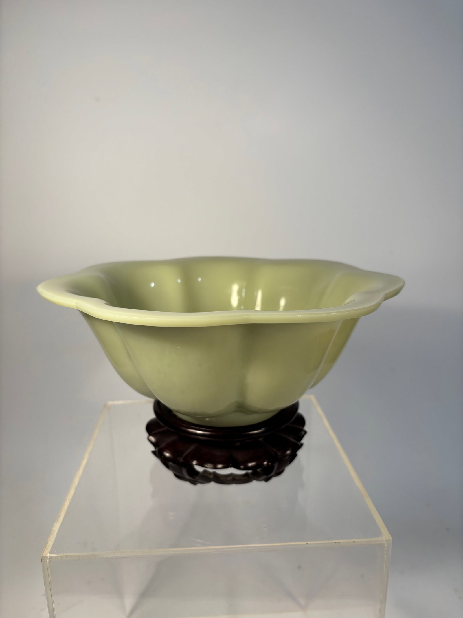 A Chinese Peking Glass Bowl – Celadon Yellow-Green jade like: Qing Dynasty(1644-1912); A luminous Chinese Peking glass bowl, molded in a lobed lotus blossom form with soft curves rising to a slightly flared rim. The glass is an elegant celadon yellow-green tone,