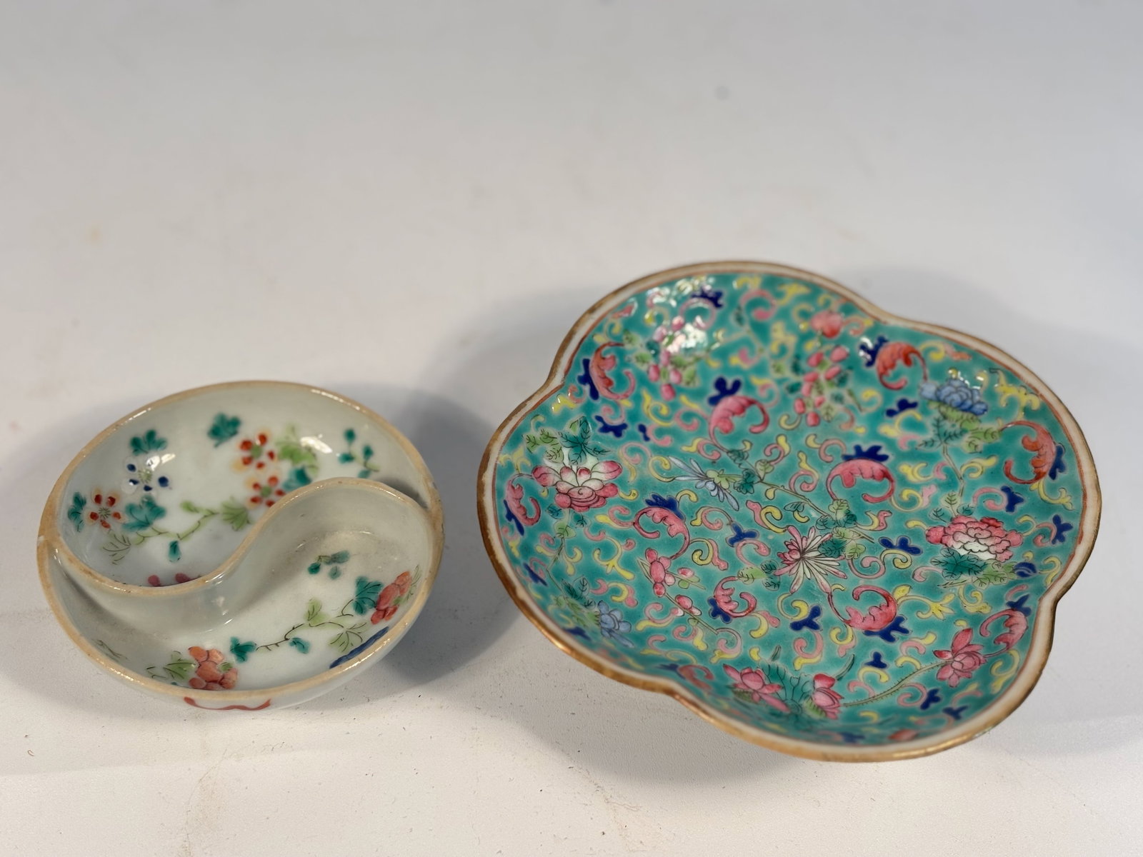 Set of Two Chinese Famille Rose Dishes: Qing Dynasty (1644-1912); A Chinese porcelain divided condiment dishes, each shaped in the traditional yin-yang form and hand-painted in famille rose enamels with floral sprays. Another lobed dish tur