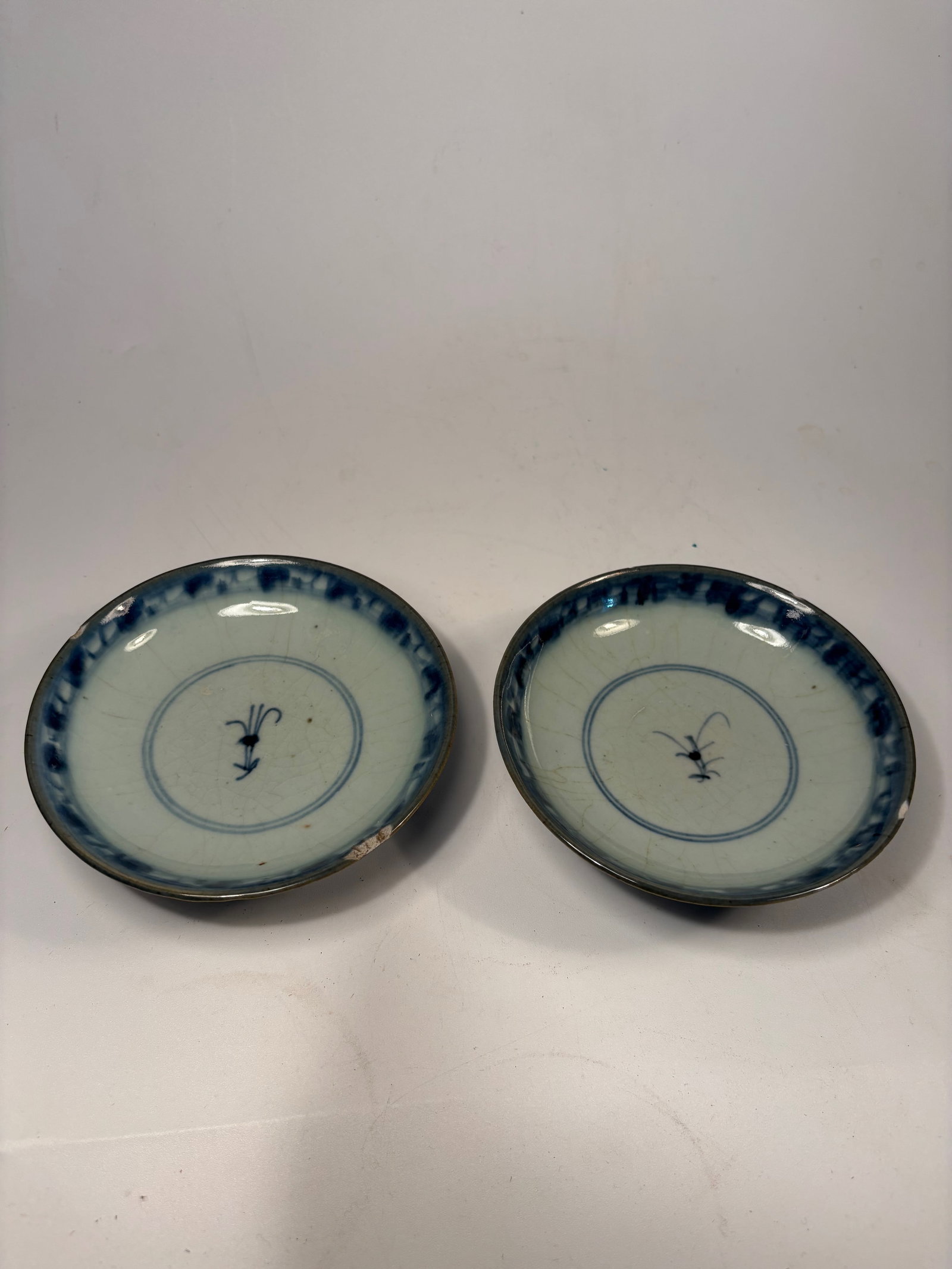 A Pair of Chinese blue and white porcelain dishes: Late Ming Dynasty or early Qing dynasty (17th-18th century) ; finely painted blue-and-white porcelain bowl, the exterior decorated with floral scroll panels in cobalt blue, and the interior with a cen