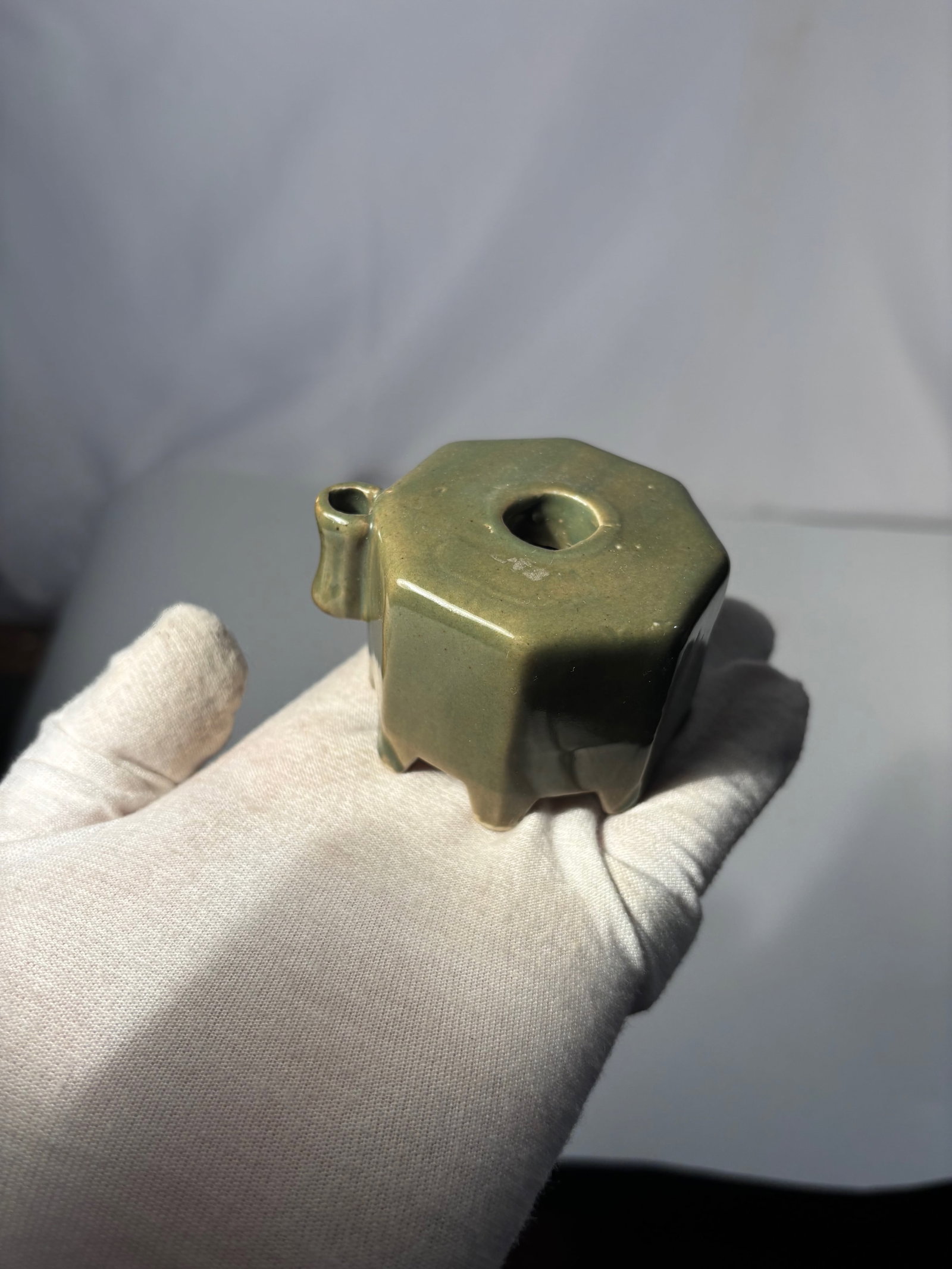 A Japanese Celadon-Glazed Water Dropper (Suiteki): 19th century , A Japanese celadon-glazed water dropper (suiteki), made for use in the scholar’s studio when preparing ink for calligraphy or painting. The small vessel is formed with a rounded body