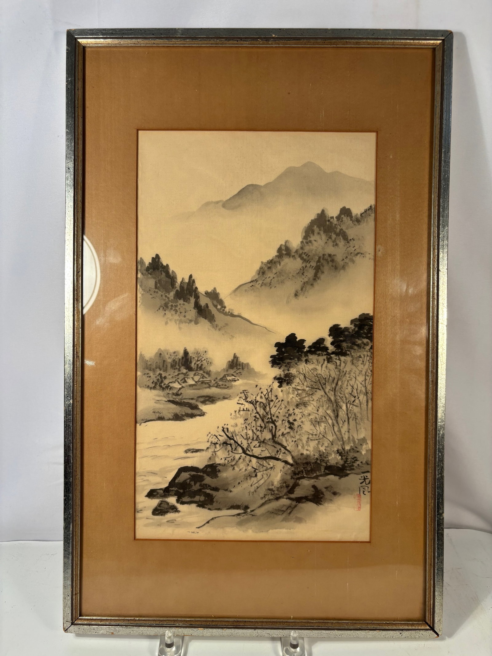 A Japanese Ink Landscape Painting on Silk, Signed Kofu, meiji period 1868-1912: Japanese ink and wash landscape painting depicting a mountainous river scene with trees and mist. Executed in ink on silk in the traditional literati style. The work bears the signature Kofu (??) and