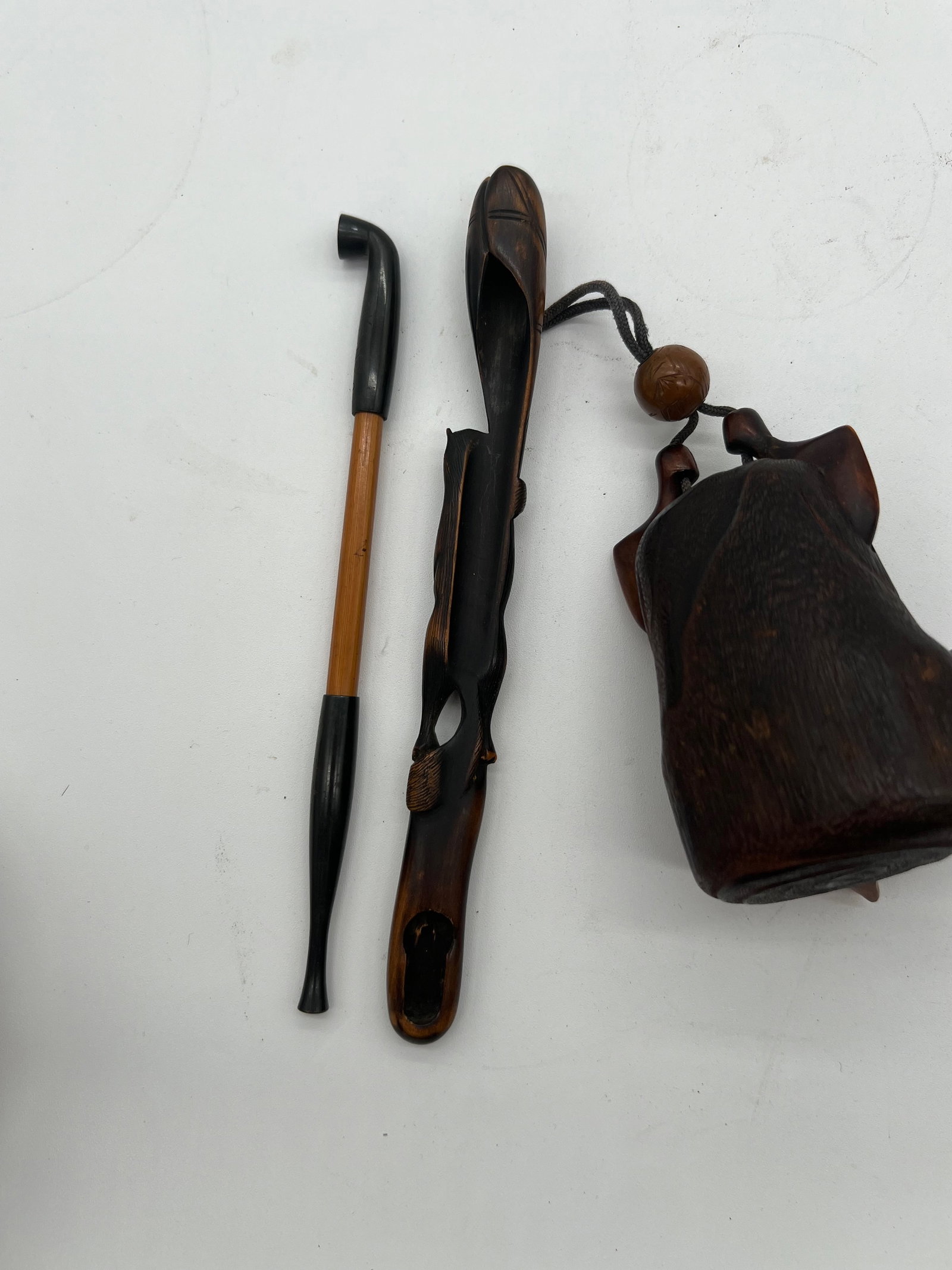 A Japanese Kiseruzutsu with Tabako-ire: Late 19th century to early 20th cenury; Pipe holder with tobacco holder in the form of daruma.Used for carrying smoking pipes and tobacco, kiseruzutsu were often elaborate and featured intricate tobac