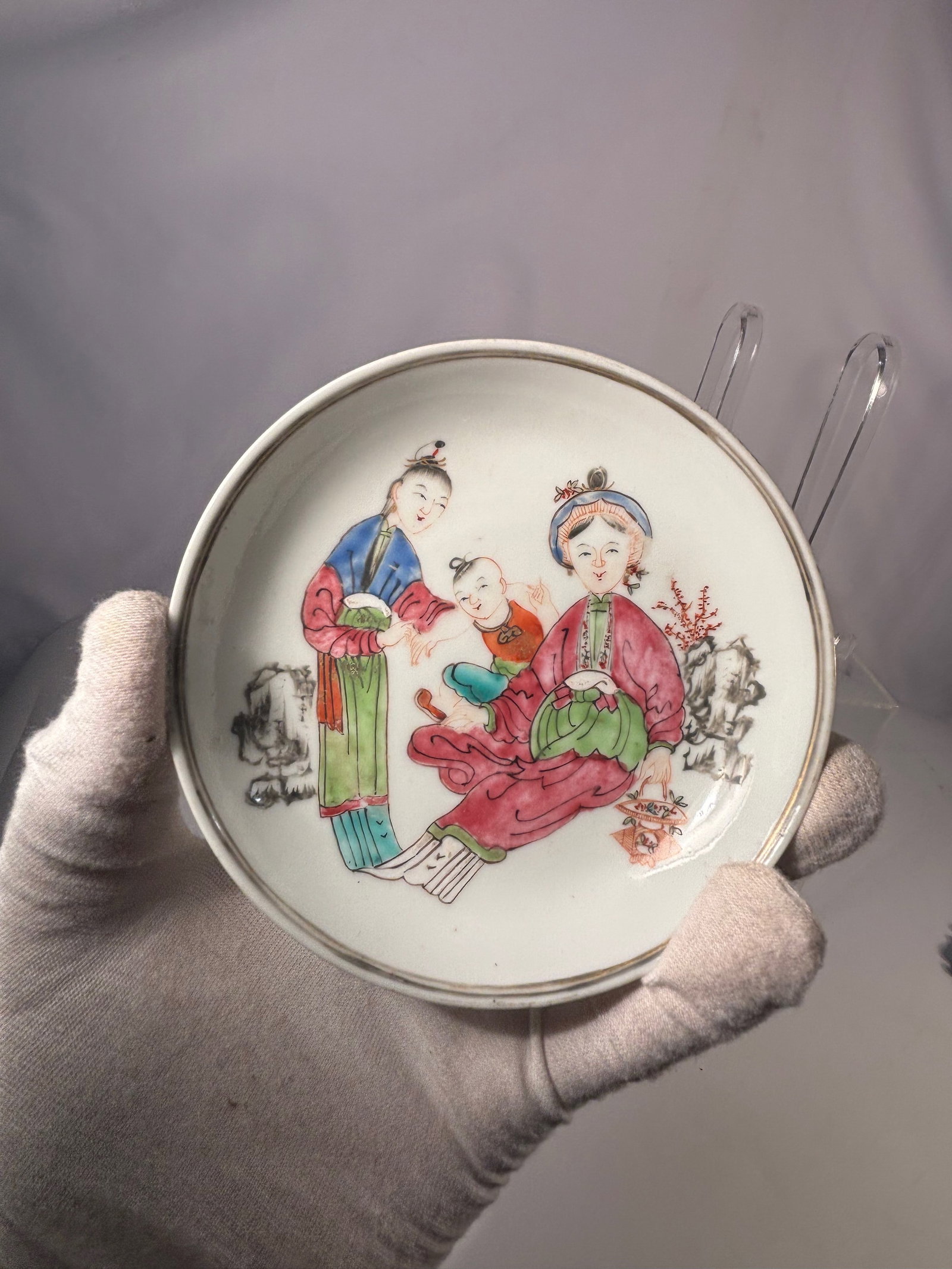 A Chinese Porcelain Dish with Figural Scene Decoration, YongZheng Period (1723-1735): A Chinese porcelain dish, enamel-painted to the interior with a figural scene depicting ladies and a child in a garden setting. The decoration is executed in a Yongzheng famille rose palette, with sof