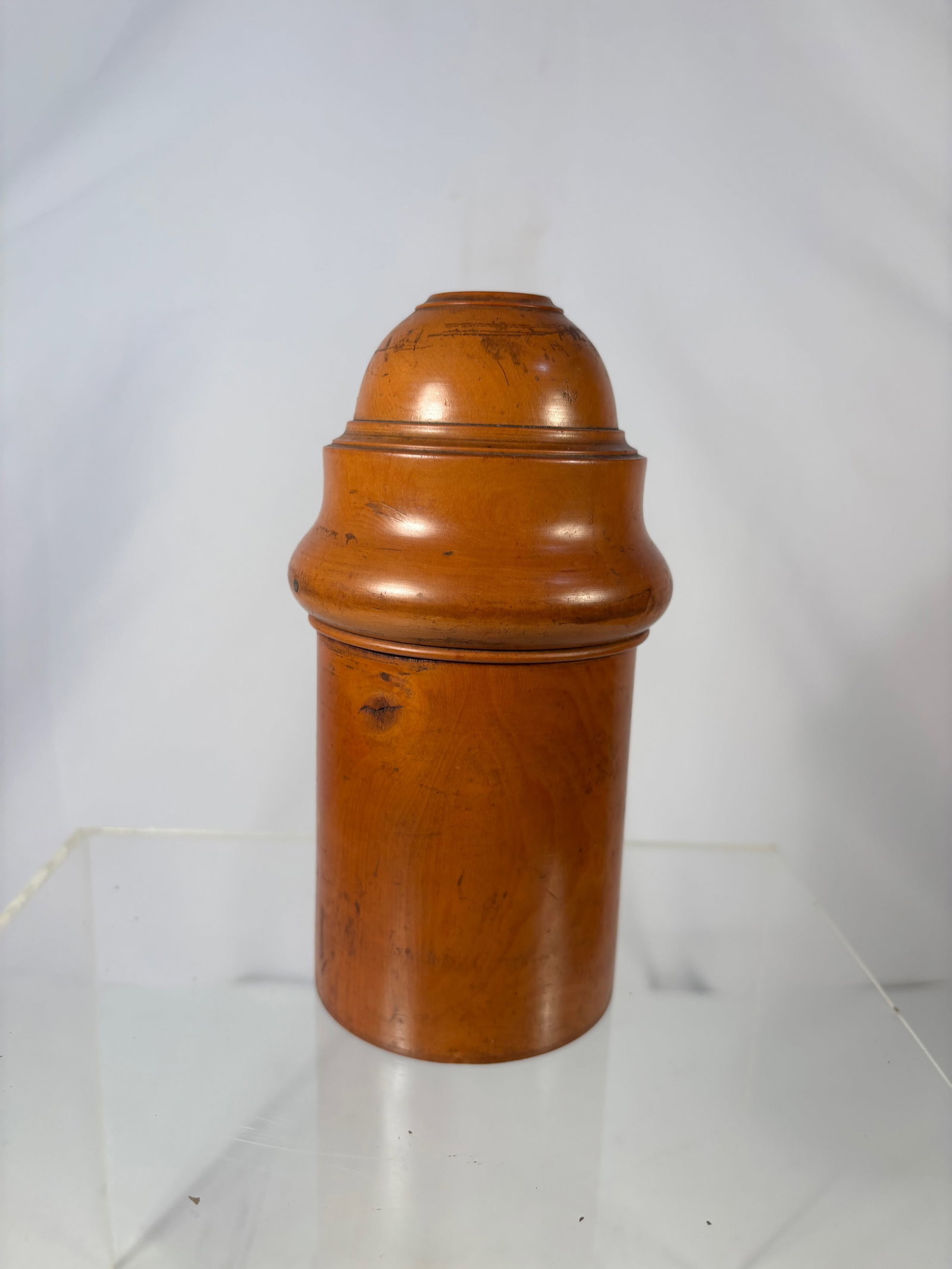 A Fine Boxwood Travelling Medicine Bottle , London , 19th Century: Turned boxwood cylindrical case with domed lid and screw-off base revealing a pill compartment, the base impressed “....... LONDON” with crown mark.?Dimensions?Height: 4.75 inches; Diameter: