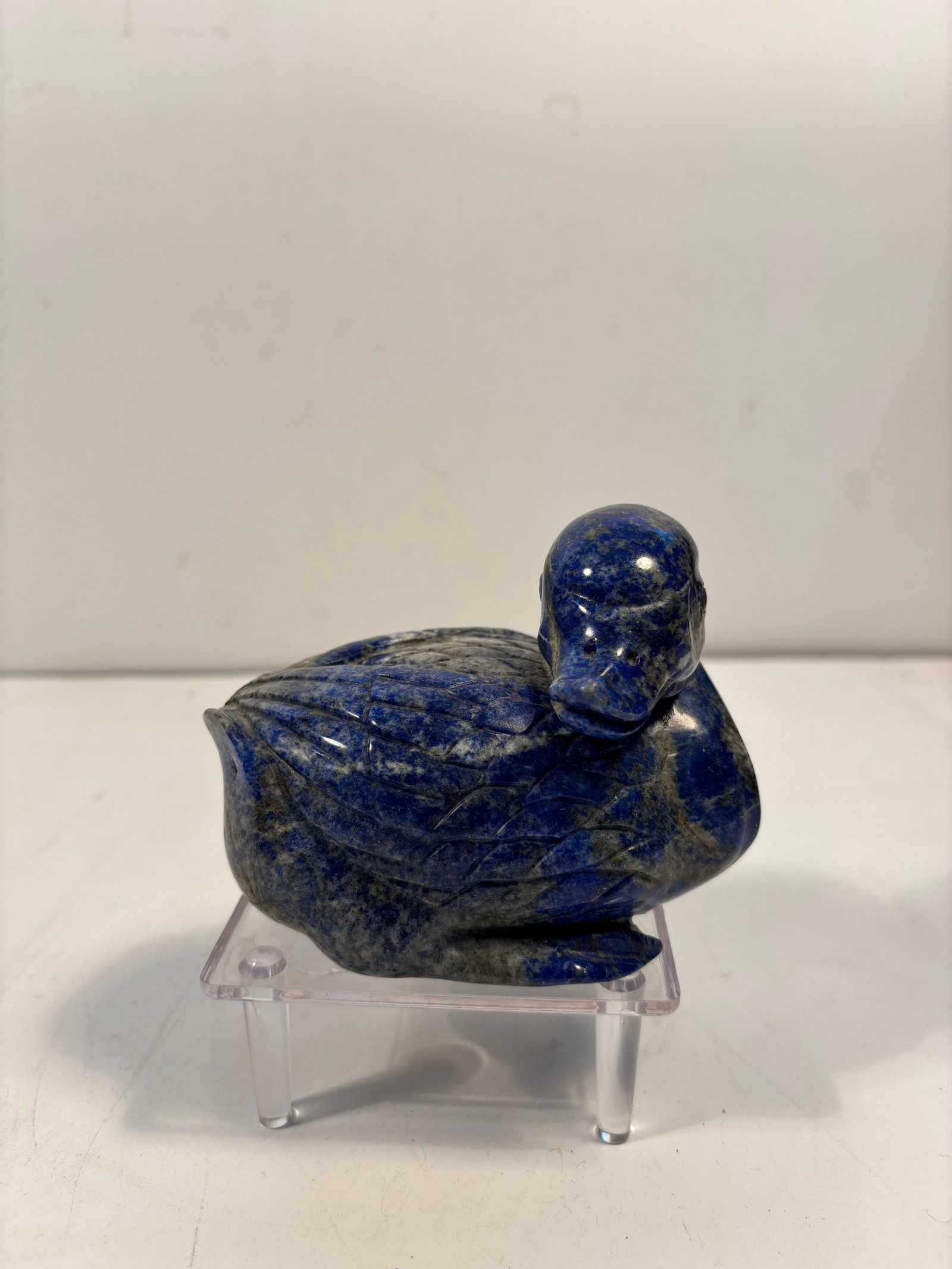 A Heavy Chinese hand carved lapis lazuli duck sculpture paper weight: It has intense blue color with gold flecks of pyrite. The stone is of deep cobalt blue with natural inclusions of white calcite and golden pyrite. Smoothly polished surface with well-defined wings and