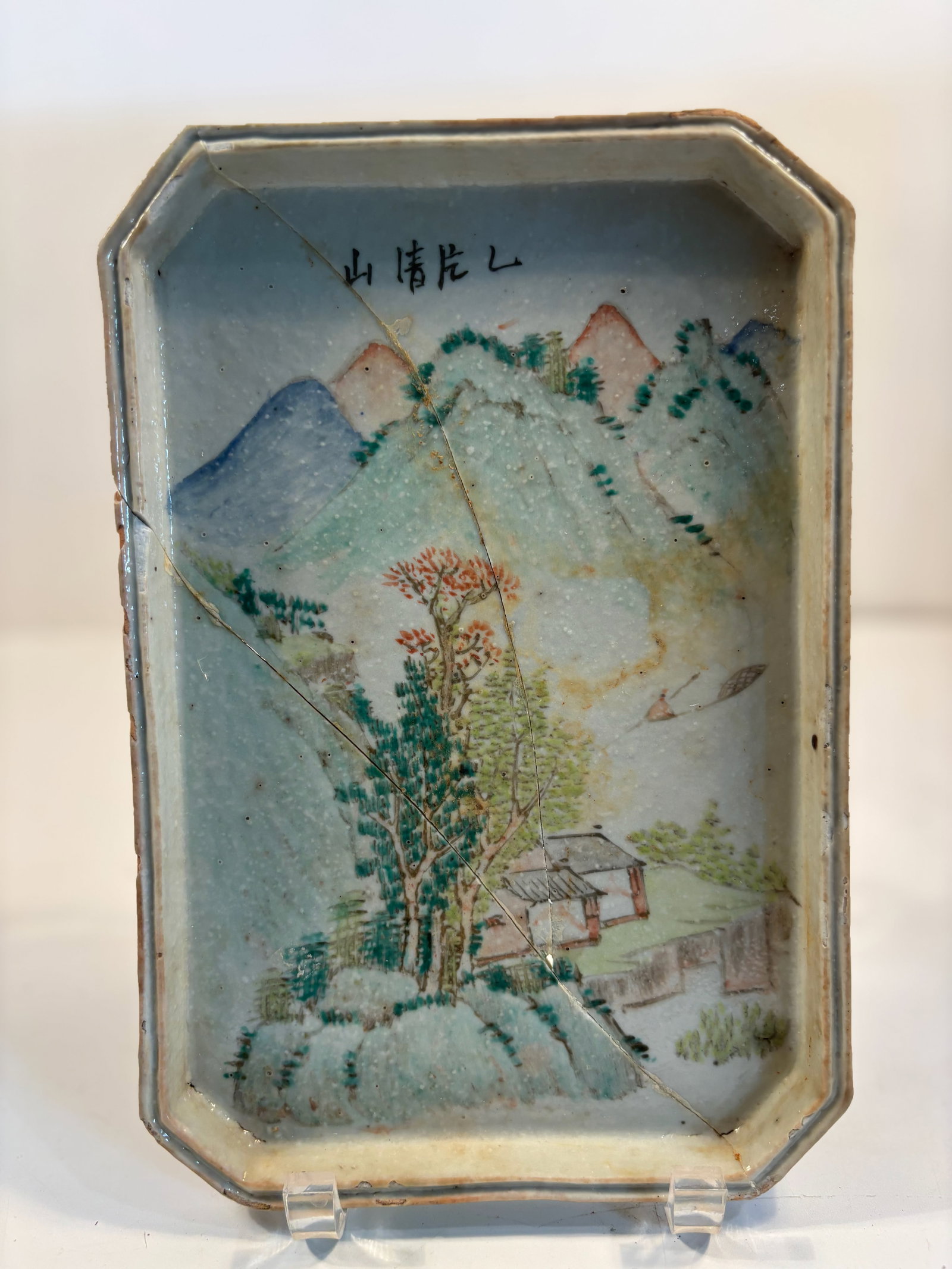 A Chinese Qianjiang hand painted porcelain tray: Qing Dynasty (1644-1912);Features a classic landscape scene with mountains, a scholar’s retreat, trees, and a boat.rectangular form with chamfered corners” . Dimensions?Length: 10 inches; Widt