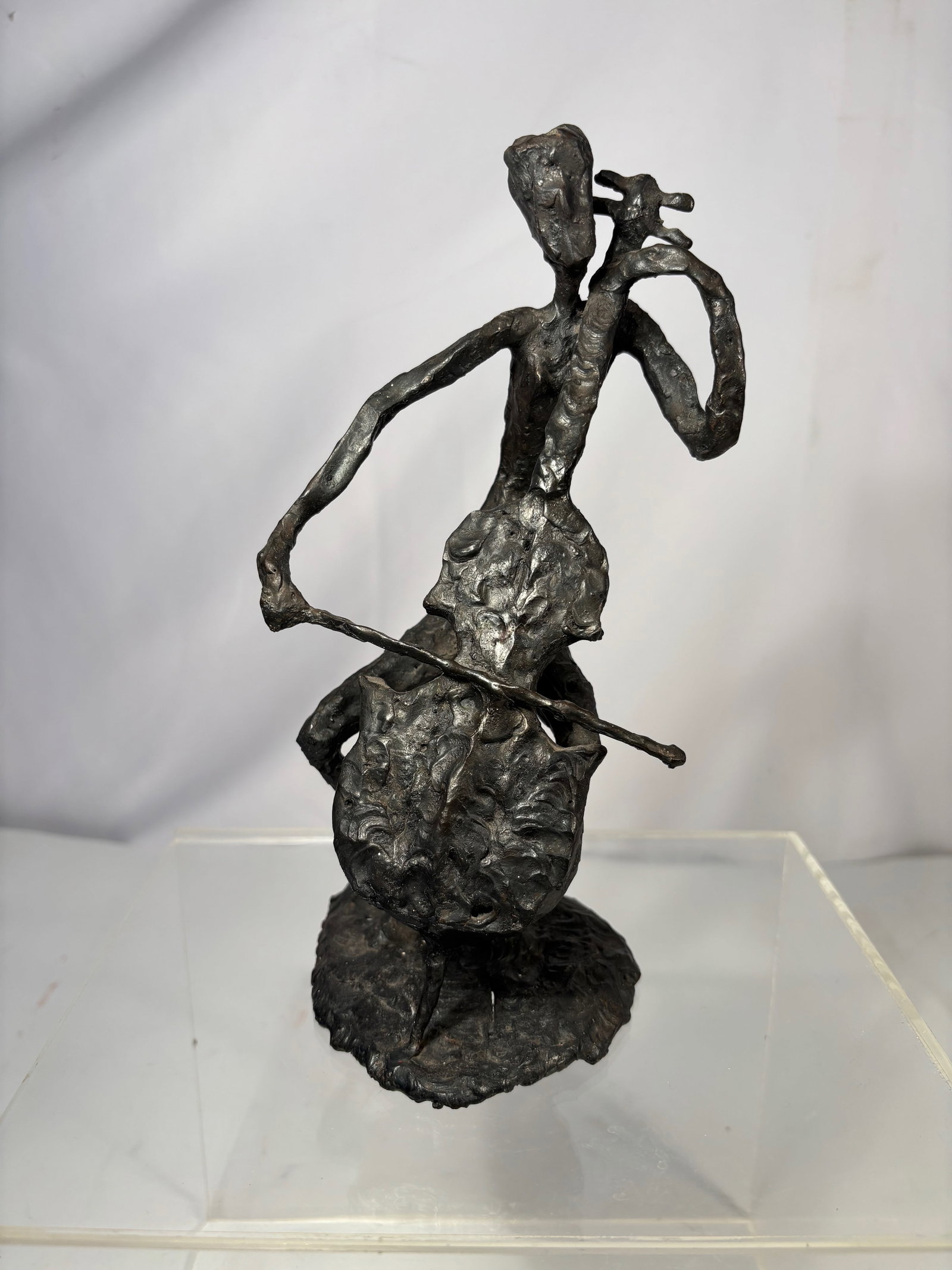 a Expressionist Bronze Figure, Signed “LJK: Cast bronze sculpture depicting an elongated standing human figure rendered in a highly expressionist style. The surface is deliberately rough and heavily worked, emphasizing gesture, movement, and ps