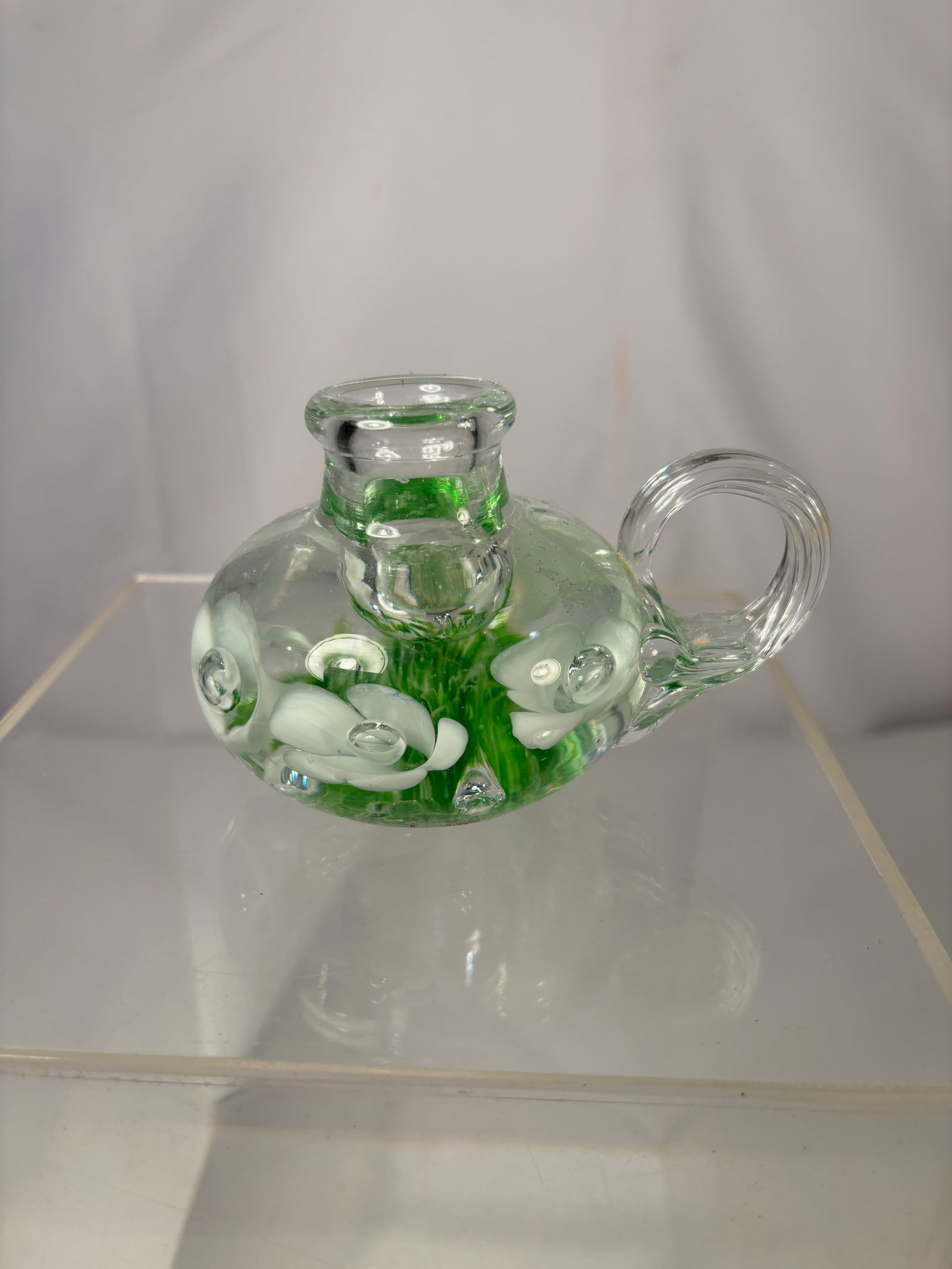 Studio Art Glass Miniature Ewer w/ Green & White Floral Decoration Signed St Joe Claire: Hand-blown studio art glass miniature ewer featuring a clear body with vivid green inclusions and applied white floral decoration. The form is compact and well-balanced, with a rounded body, short nec