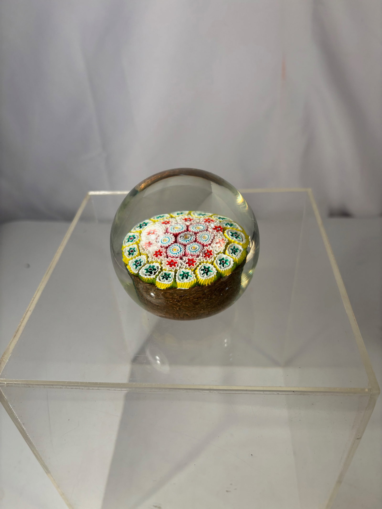 Art Glass Millefiori Paperweight with Multicolor Concentric Cane Design: Decorative art glass paperweight featuring a classic millefiori design composed of tightly packed multicolor canes arranged in a concentric circular pattern. The vibrant palette includes red, yellow, 