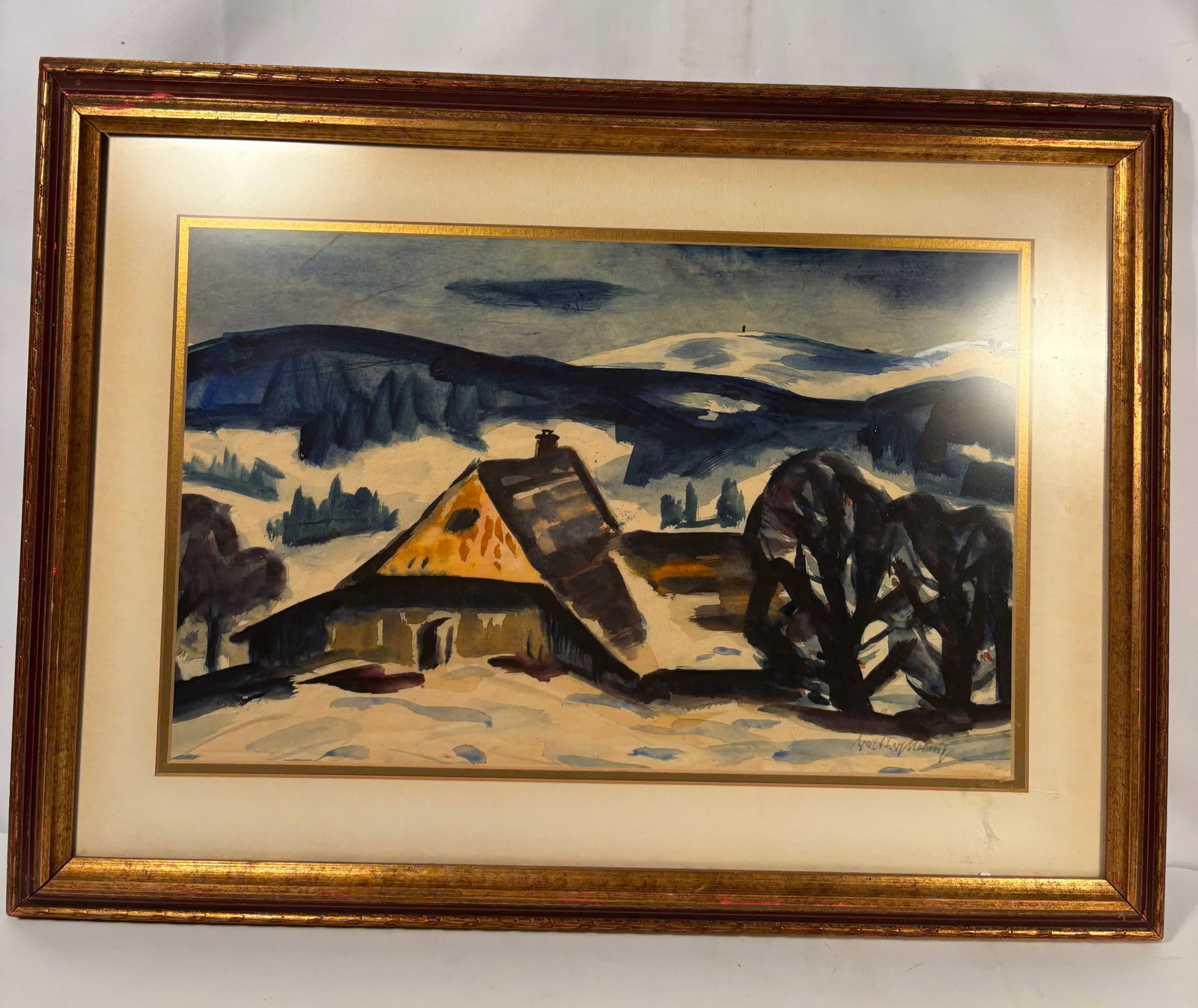 Walther Meinig (German, 1902–1987) Black Forest Winter Farmhouse Watercolor: A framed watercolor on paper by Walther Meinig, depicting a snow-covered farmhouse set within a mountainous Black Forest winter landscape. Executed in expressive blue and black washes with bold silhou