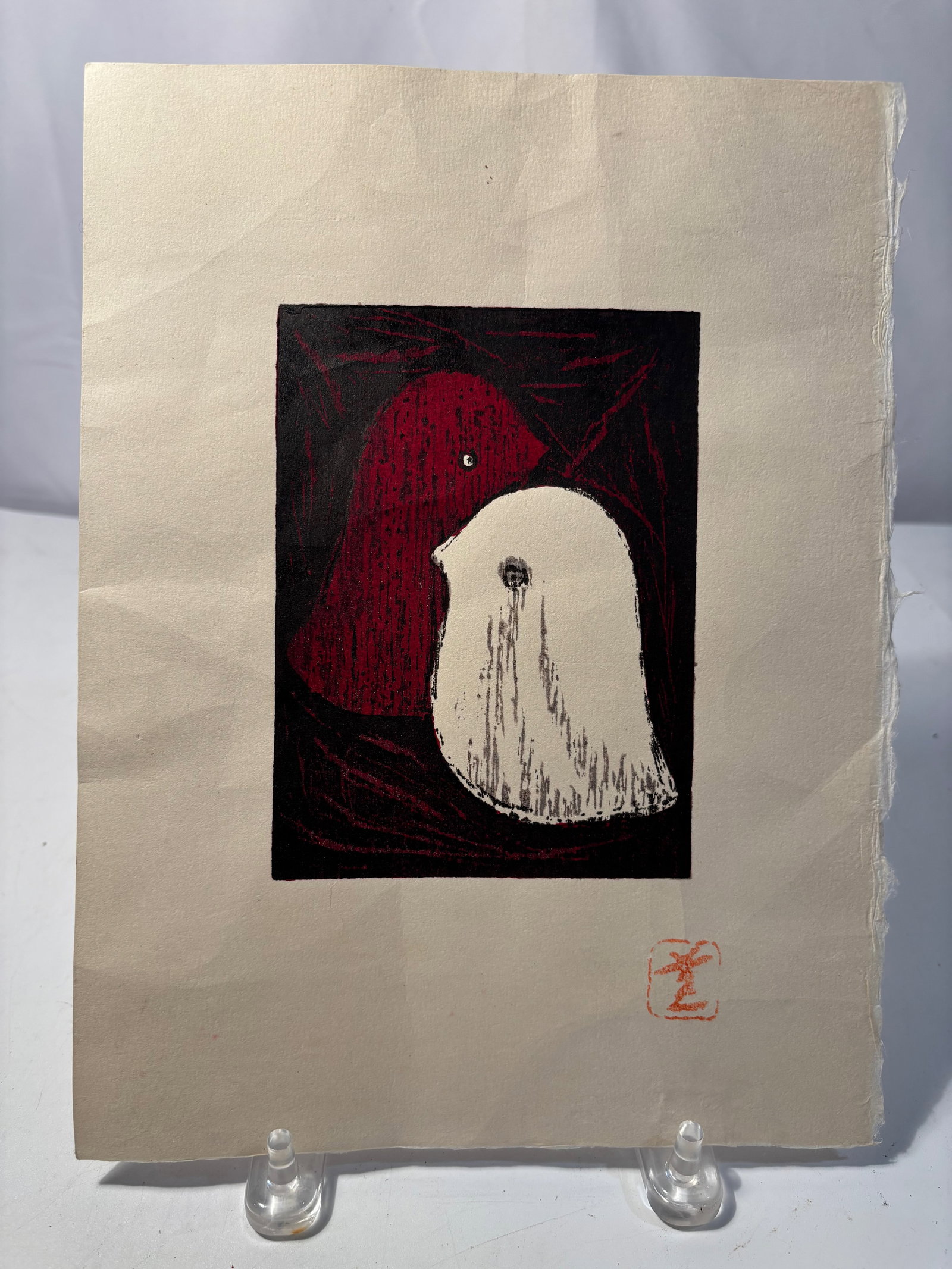 A Japanese "Two Birds" Color woodblock on paper Signed: Japanese mid-20th century s?saku hanga style color woodblock print depicting two abstracted birds, one rendered in deep red and the other in white, set against a dark expressive ground with carved lin