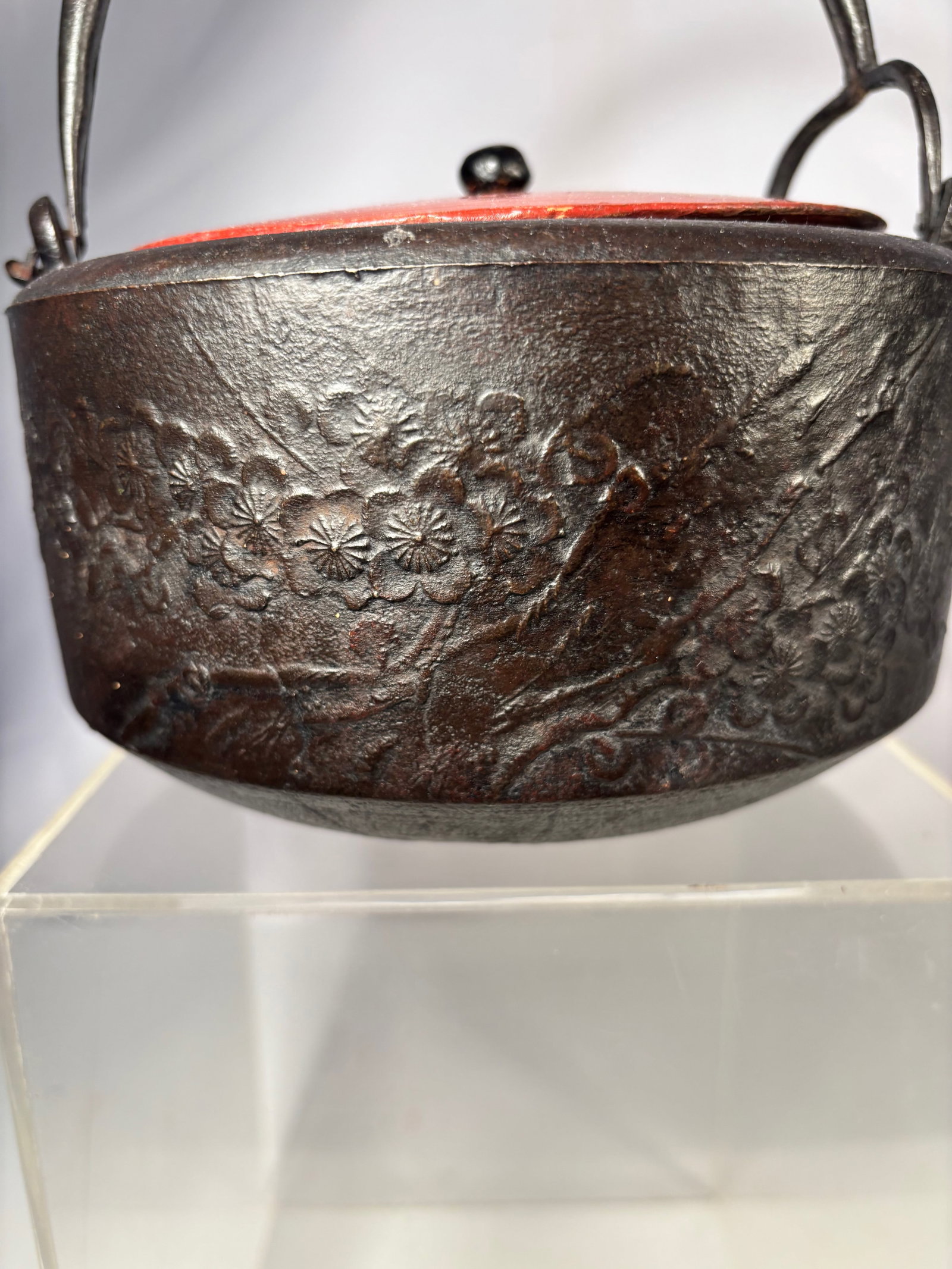 Japanese Cast Iron Tetsubin Teapot, Meiji Period (1868–1912): A Japanese cast iron teapot (tetsubin) dating to the Meiji period (1868–1912). The vessel is of rounded form with an integrated spout and arched handle, cast with a subtly textured surface typical o