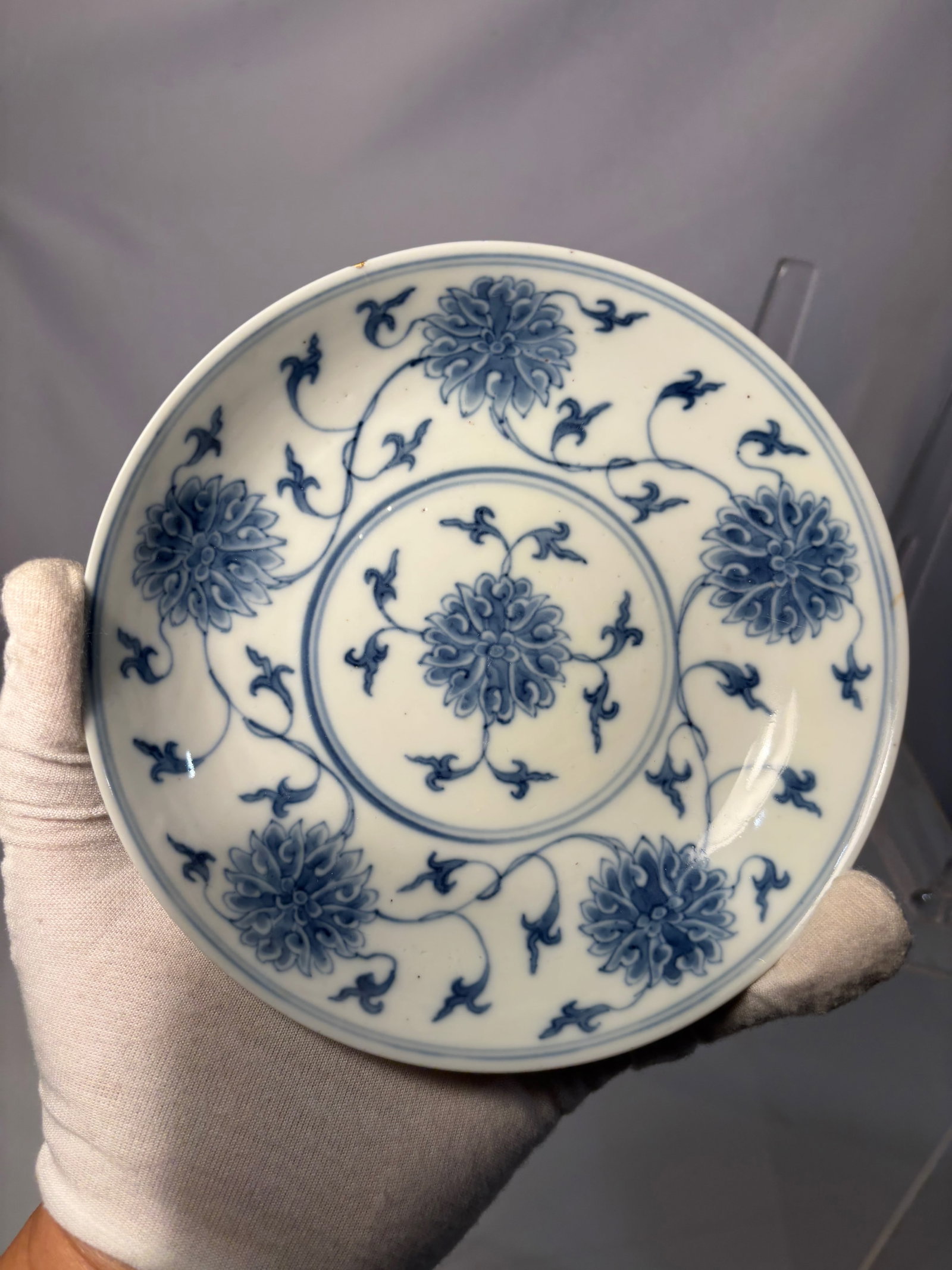 A Chinese Blue and White Porcelain Plate with Chrysanthemum Scroll Design, Guangxu Mark,: A Chinese blue and white porcelain plate decorated with stylized chrysanthemum blooms and scrolling vine motifs in underglaze cobalt blue. The center features a floral roundel medallion, encircled by 