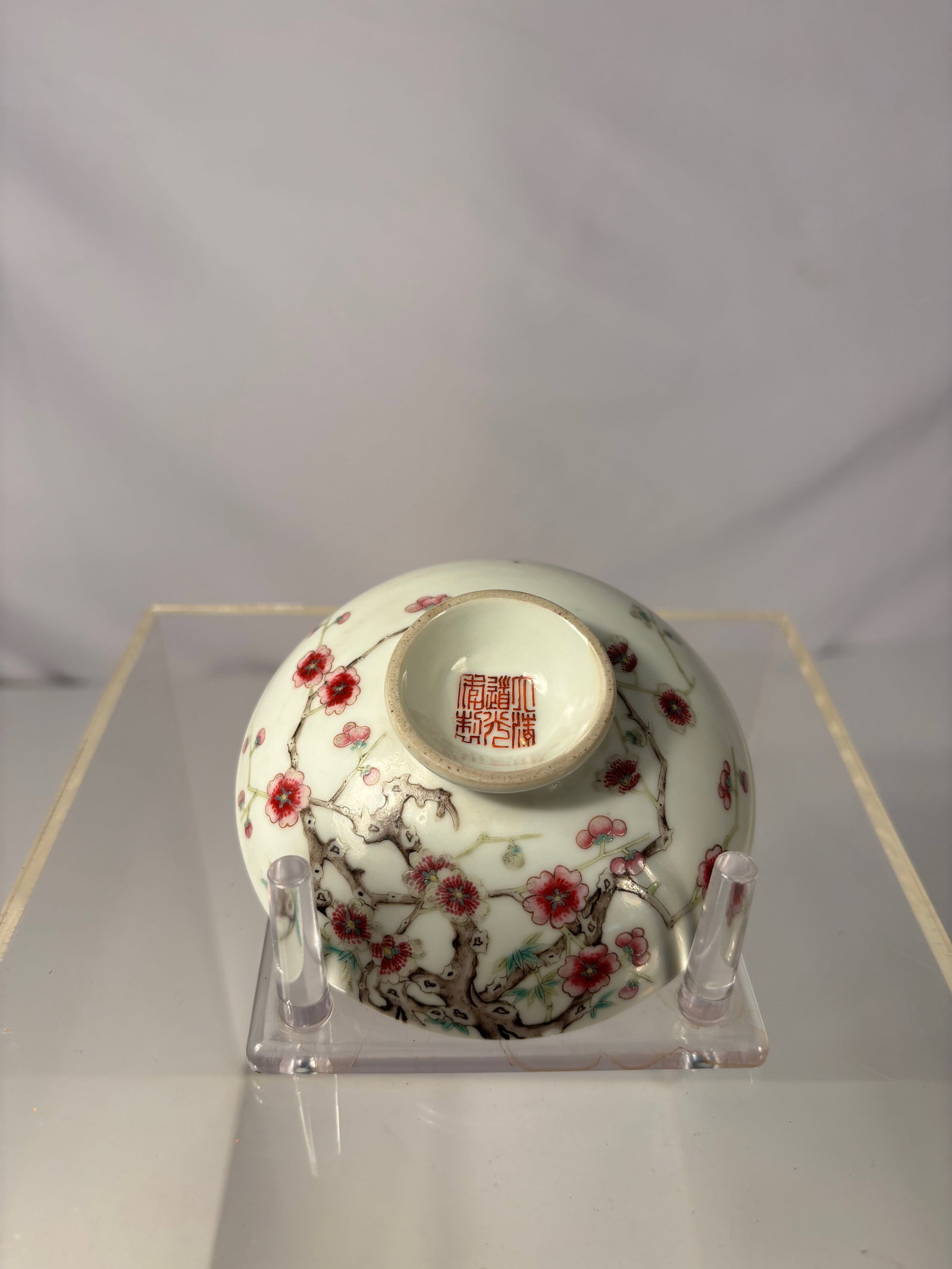 A Chinese Famille Rose Porcelain dish with Prunus Blossoms, six-character Daoguang mark: Qing dynasty(1644-1912); delicately painted in famille rose enamels with flowering prunus branches, the gnarled trunks extending around the sides and issuing buds and blossoms in red and white. The ba
