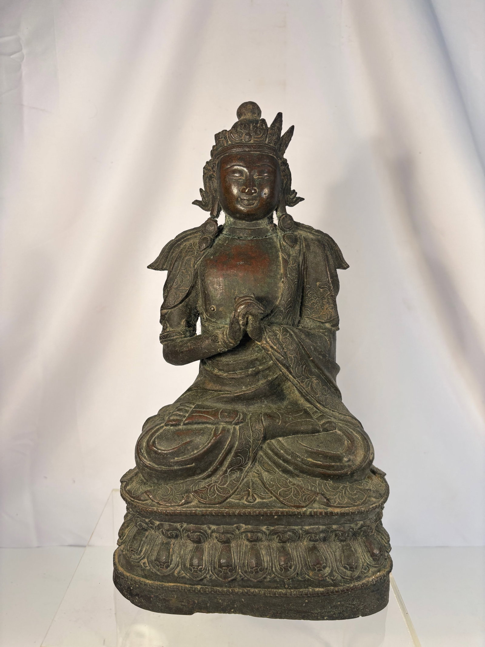 A Ming Dynasty Bronze Bodhisattva, Hongzhi First Year (1488): A finely cast inscribed bronze Bodhisattva, seated in vajrasana on a double-lotus base, the hands held together in anjali mudra (gesture of reverence). The figure is adorned with an elaborate five-poi