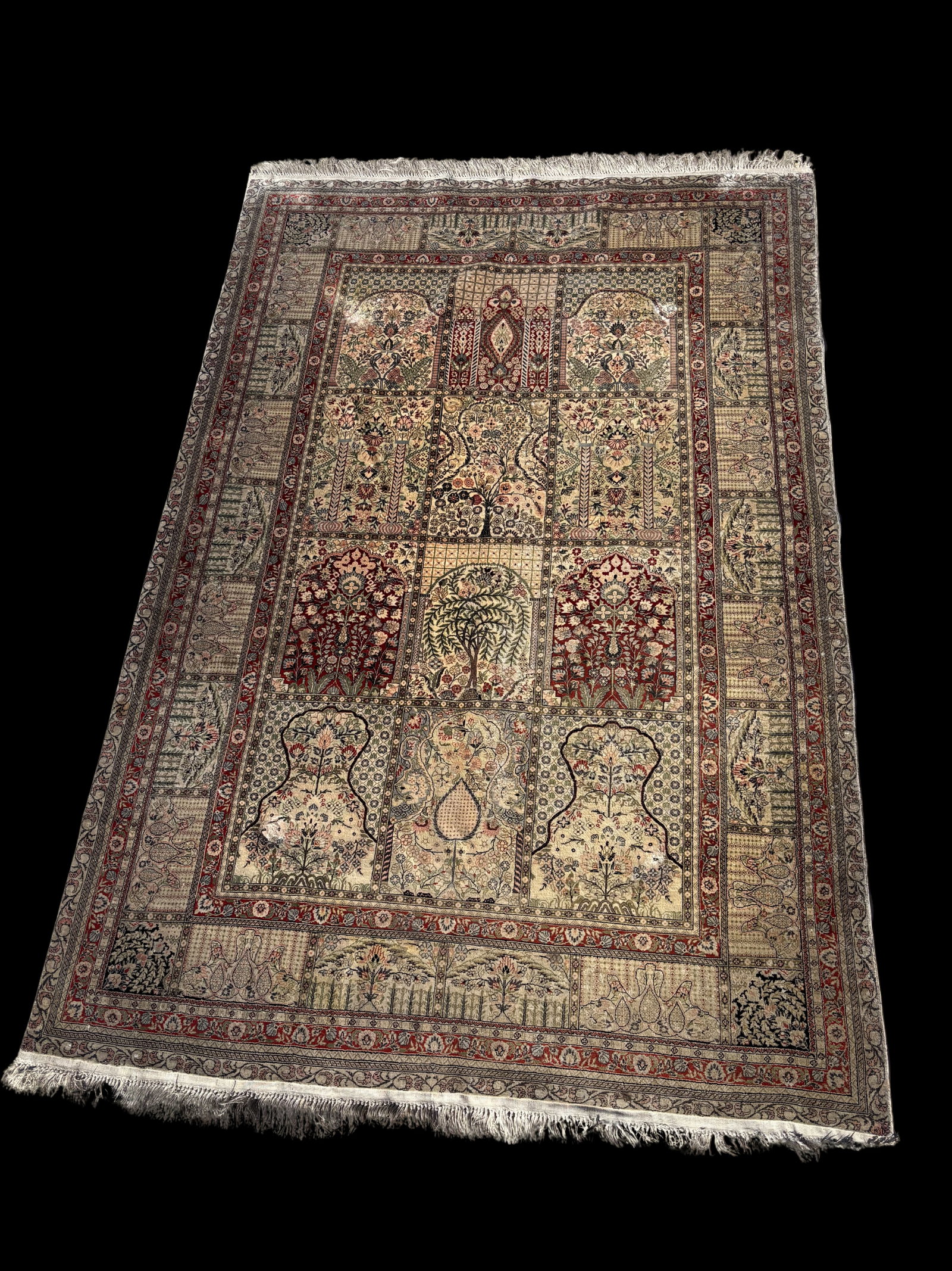 A Hand-Knotted Silk Kashmir-Style Garden Panel Rug w/ Tree of Life Design: This finely detailed hand-knotted silk rug is crafted in the Kashmir style and features a classic “garden panel” design. The field is divided into multiple compartments, each displaying intric