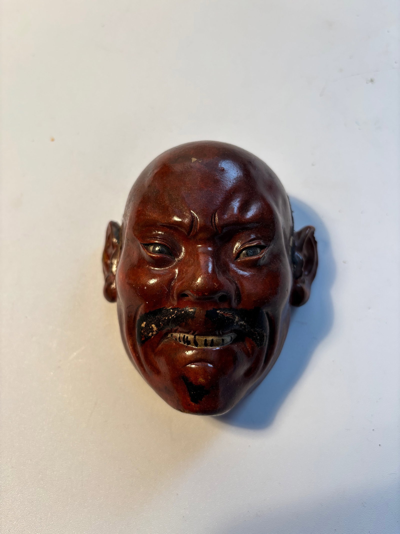 A Japanese wood lacquer mask: 19th century ; Dimensions?High: 3.75 inches