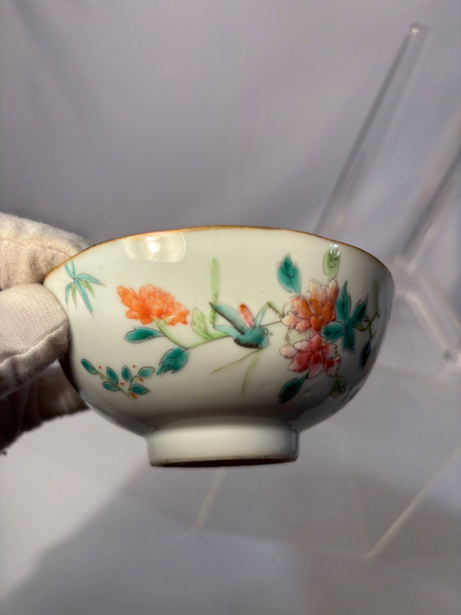 A Chinese Famille Rose Bowl with Floral Decoration, Chenghua Mark: A Chinese porcelain bowl decorated with polychrome floral enamels, the base bearing a Chenghua mark, likely later. Diameter: 4.25 inches; Height: 2 inches.