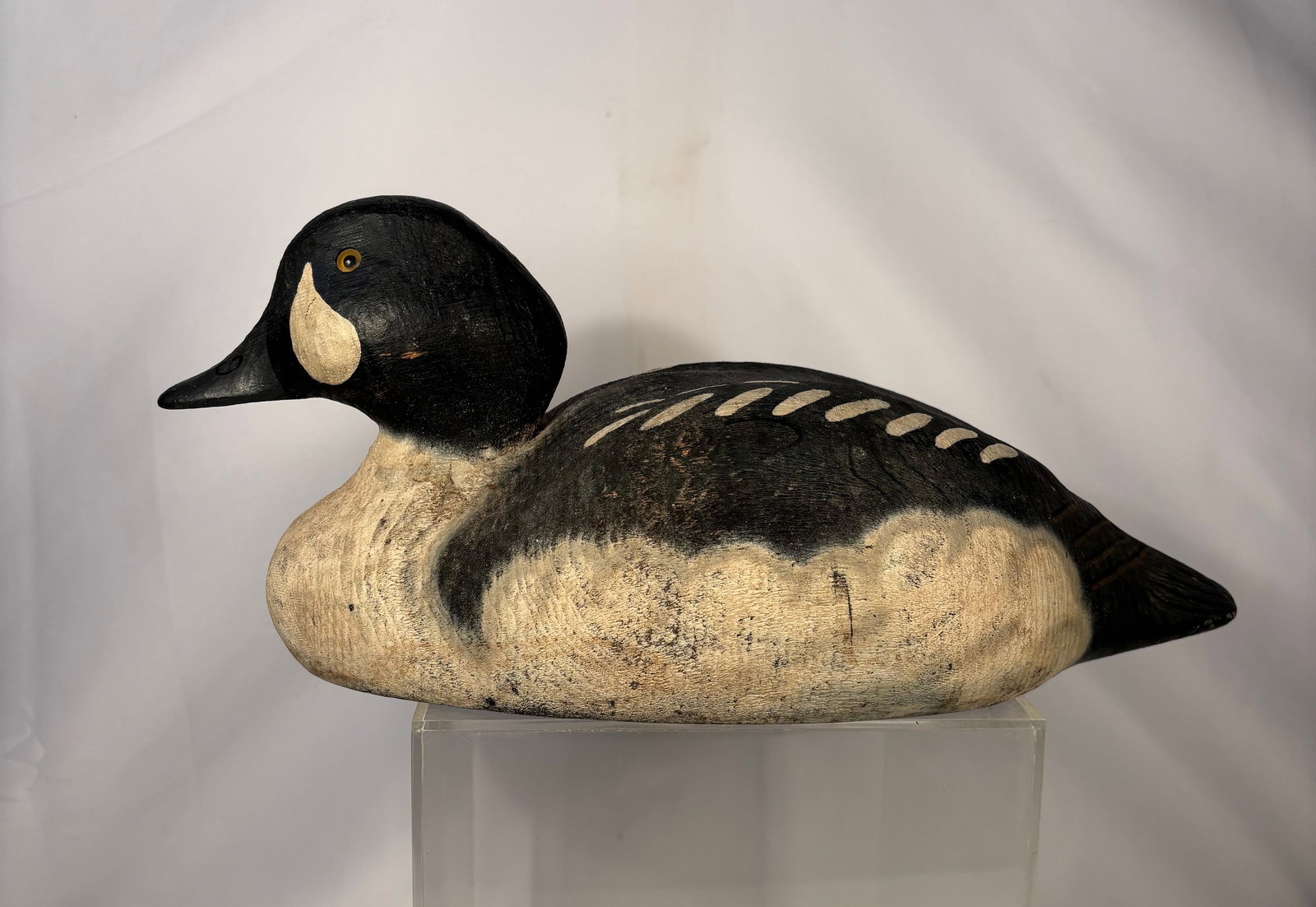Vintage Herter’s Inc. Hand-Carved Wooden Duck Decoy, Mid-20th Century: A vintage hand-carved wooden duck decoy by Herter’s Inc., depicting a hen. The decoy features a solid carved wood body with original painted surface, including characteristic wing markings and facia