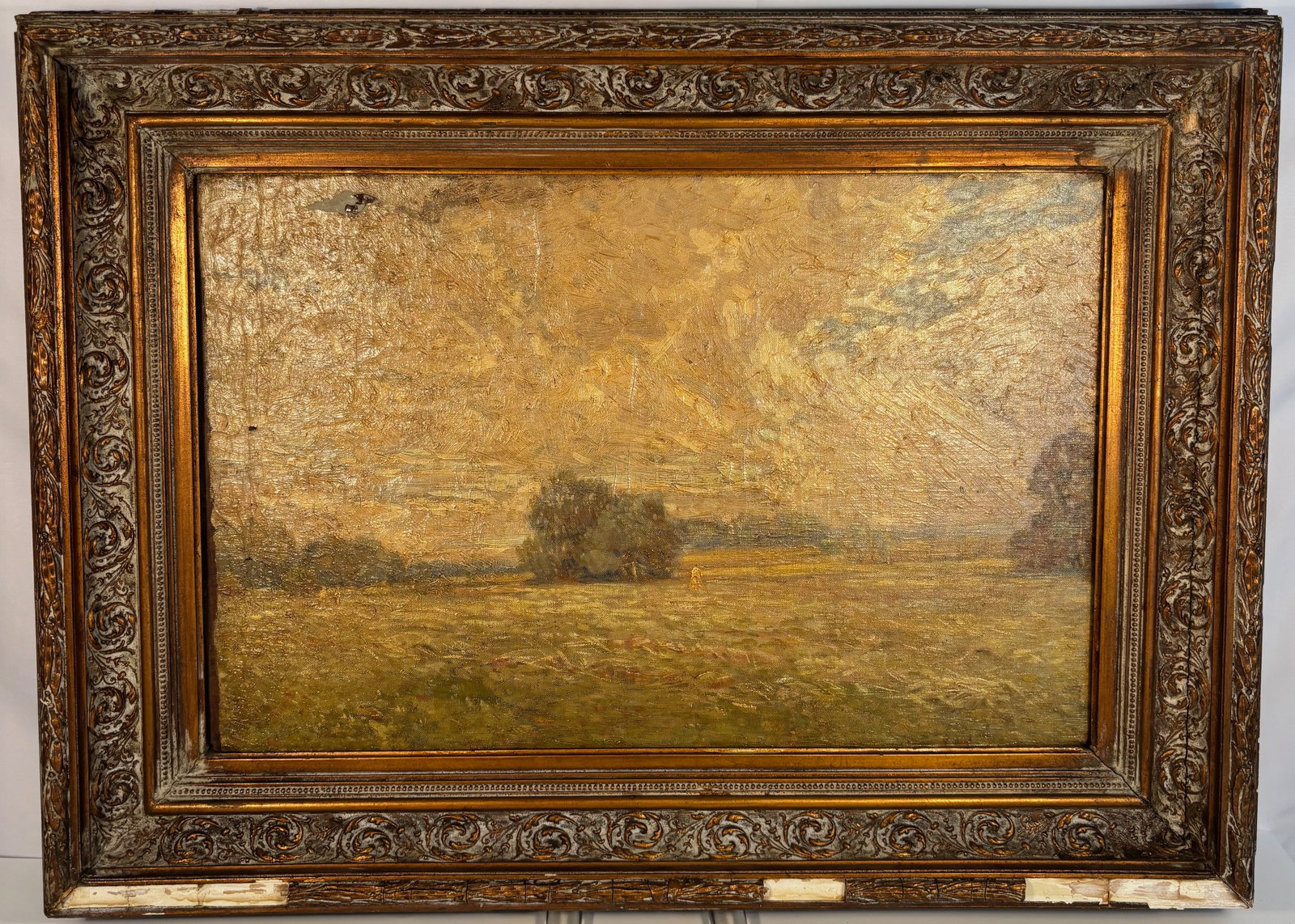 Oil on Panel Landscape Painting, Pastoral Field with Trees: 19th century to early 20th century; depicting an open pastoral field with trees under a clouded sky. A small figure or haystack appears in the distance, adding depth to the serene countryside view. Th
