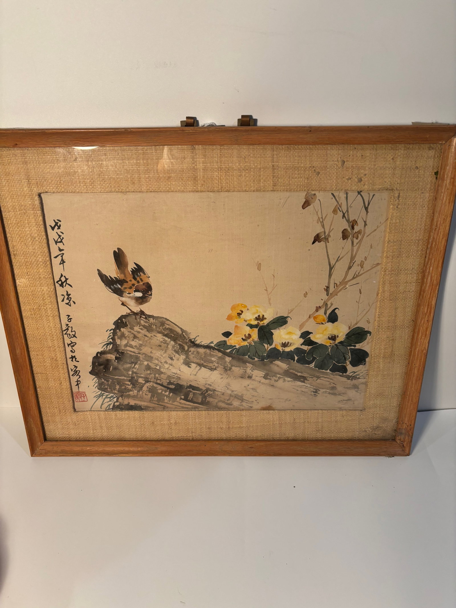 A Chinese watercolor painting by CHEN ZIYi: CHEN ZIYI (CHINESE, 1919-)?This is a traditional Chinese painting with a naturalistic subject featuring a bird perched on a branch, surrounded by foliage and yellow blossoms. Dimensions?frame: 21 inch