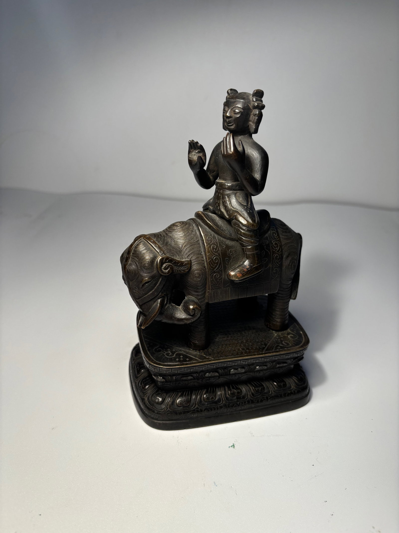 A Chinese bronze figure riding an elephant statue: Ming dynasty(1368-1644) ; he fine patterns on the clothing and the texture on the animal suggest a high level of craftsmanshipProvenance: From an prominent Midwest family collection in US.Dimensions?H