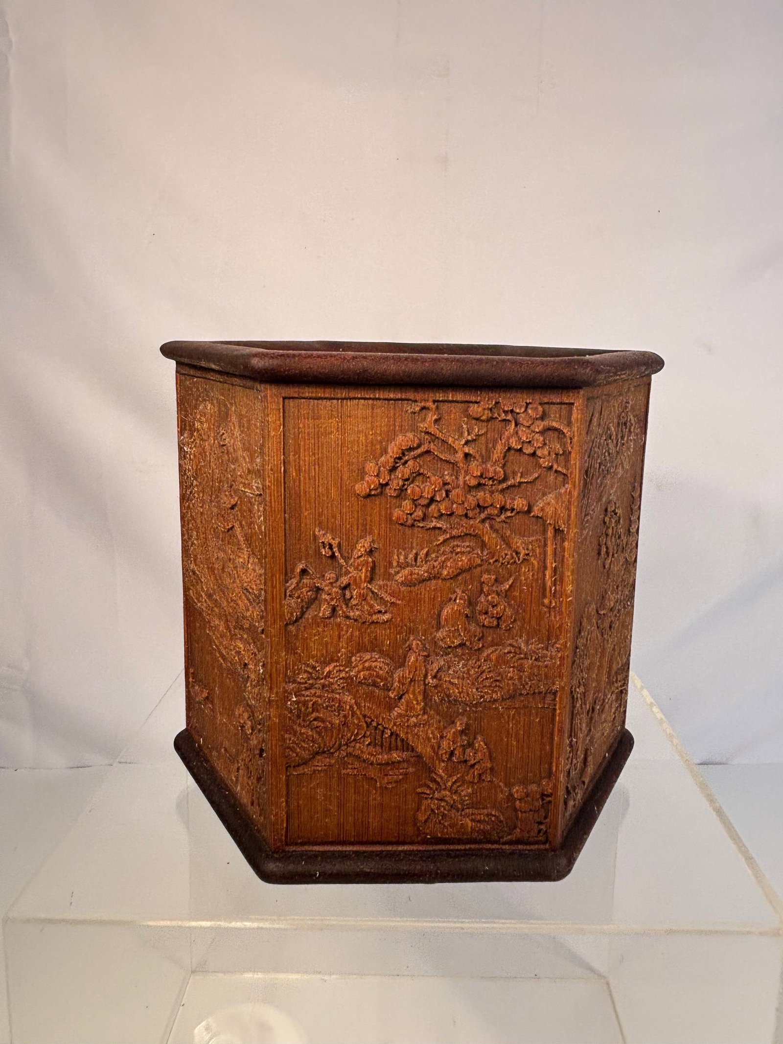 A Chinese Carved Bamboo Hexagonal Brush Pot, Late Qing/Republic Period: A Chinese hexagonal bamboo brush pot (bitong), each of the six panels finely carved in relief with landscape scenes including scholars, pavilions, pine, and a pagoda. The panels joined to form a