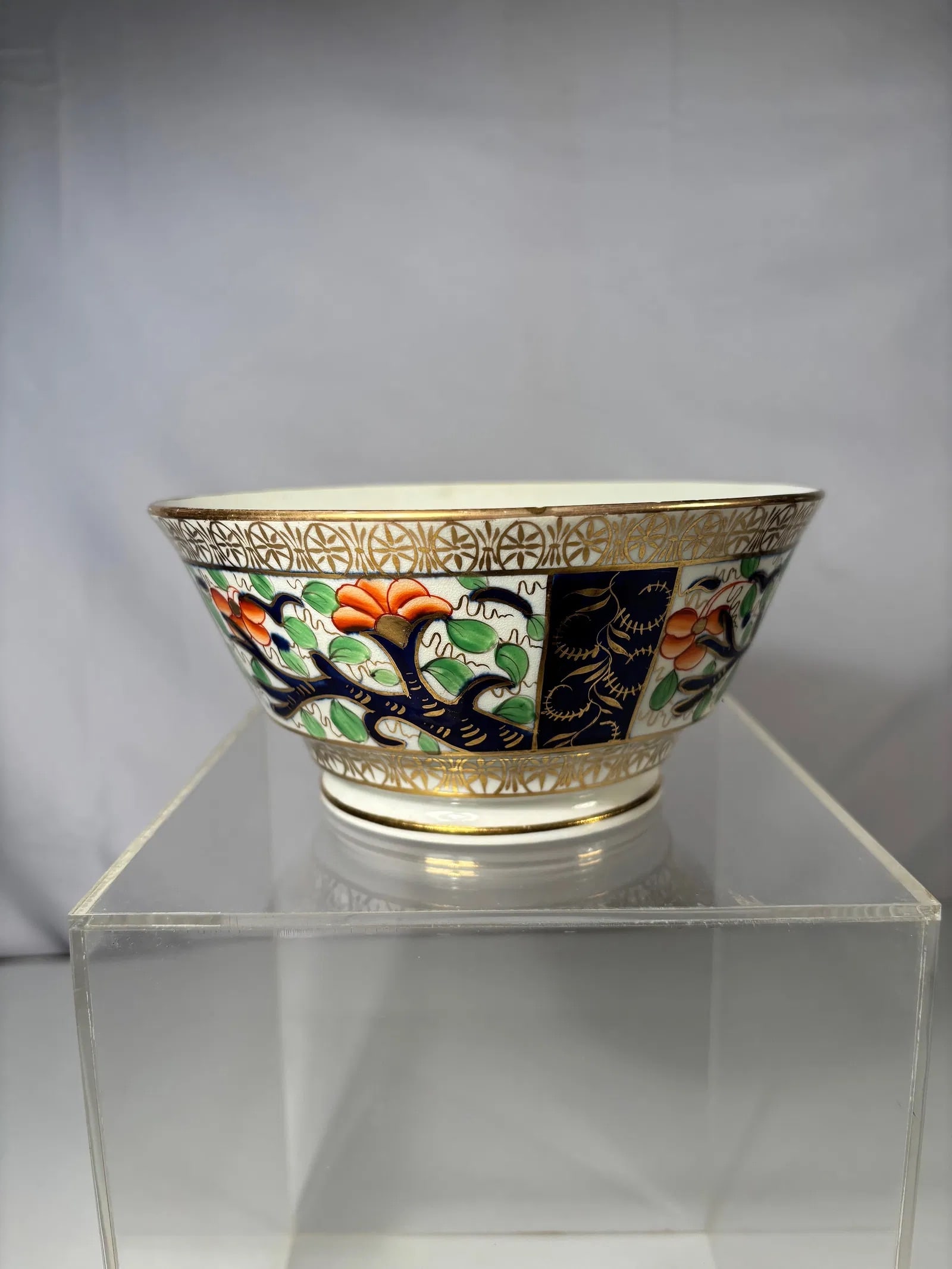 An English Porcelain Imari-Style Bowl: Regency period, ca. 1815–1830. The octagonal form richly decorated with stylized floral branches in iron-red, cobalt blue, and green enamels, accented with gilt highlights. The interior and exterior