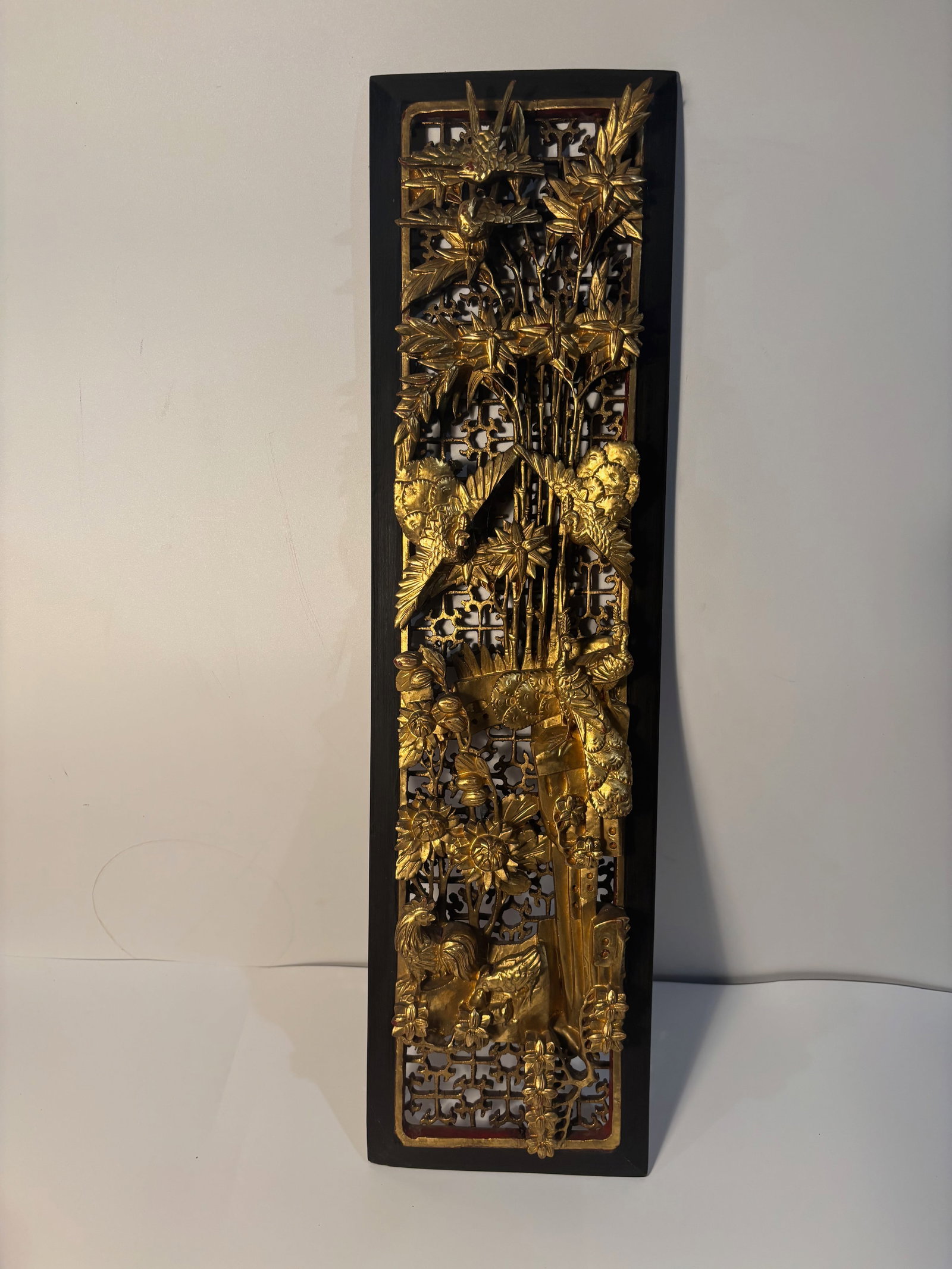 A large Chinese wood carved plaque: 19th century, Scene: The panel depicts scene of bamboo, bird at the window. It is typical in Qing Dynasty. wood, carved in high relief and gilded with gold leaf. Dimensions?height: 23 inches