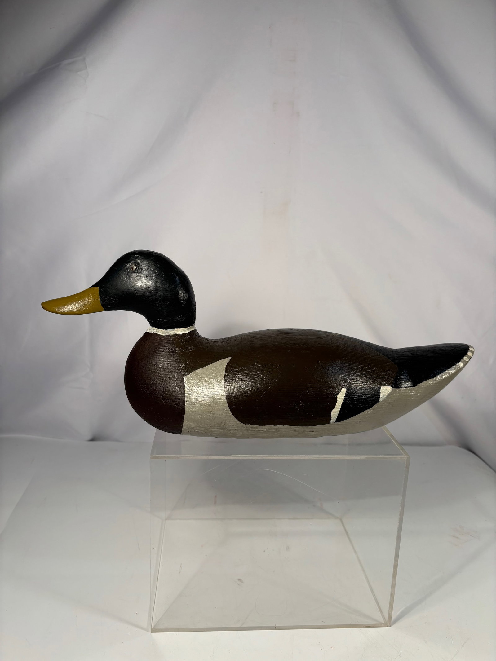 A Hand-Carved Duck Decoy, Signed Kelher, Hennepin, Illinois: Hand-carved wooden duck decoy by Kelher of Hennepin, Illinois, with hand-painted surface. The underside is inscribed “Hand Carved by Kelher, Hennepin, Ill., Repainted by Him,” indicating the d