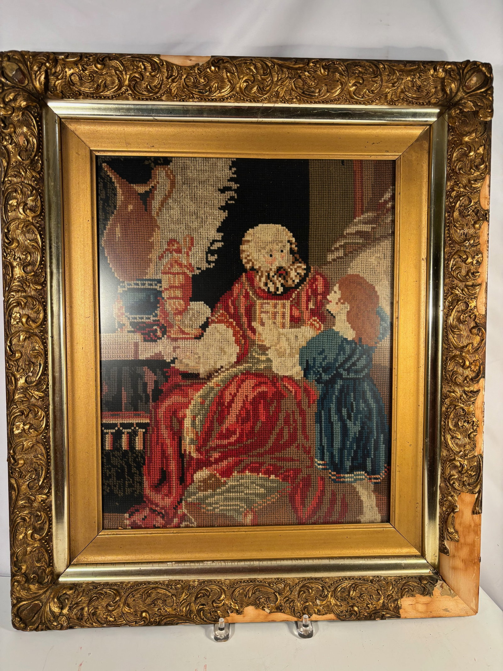 Framed Religious Needlepoint Depicting Saint Reading: Framed needlepoint tapestry depicting a religious figure in traditional robes, seated and reading from an open book. Executed in fine, closely worked stitches with vibrant coloration and detailed faci