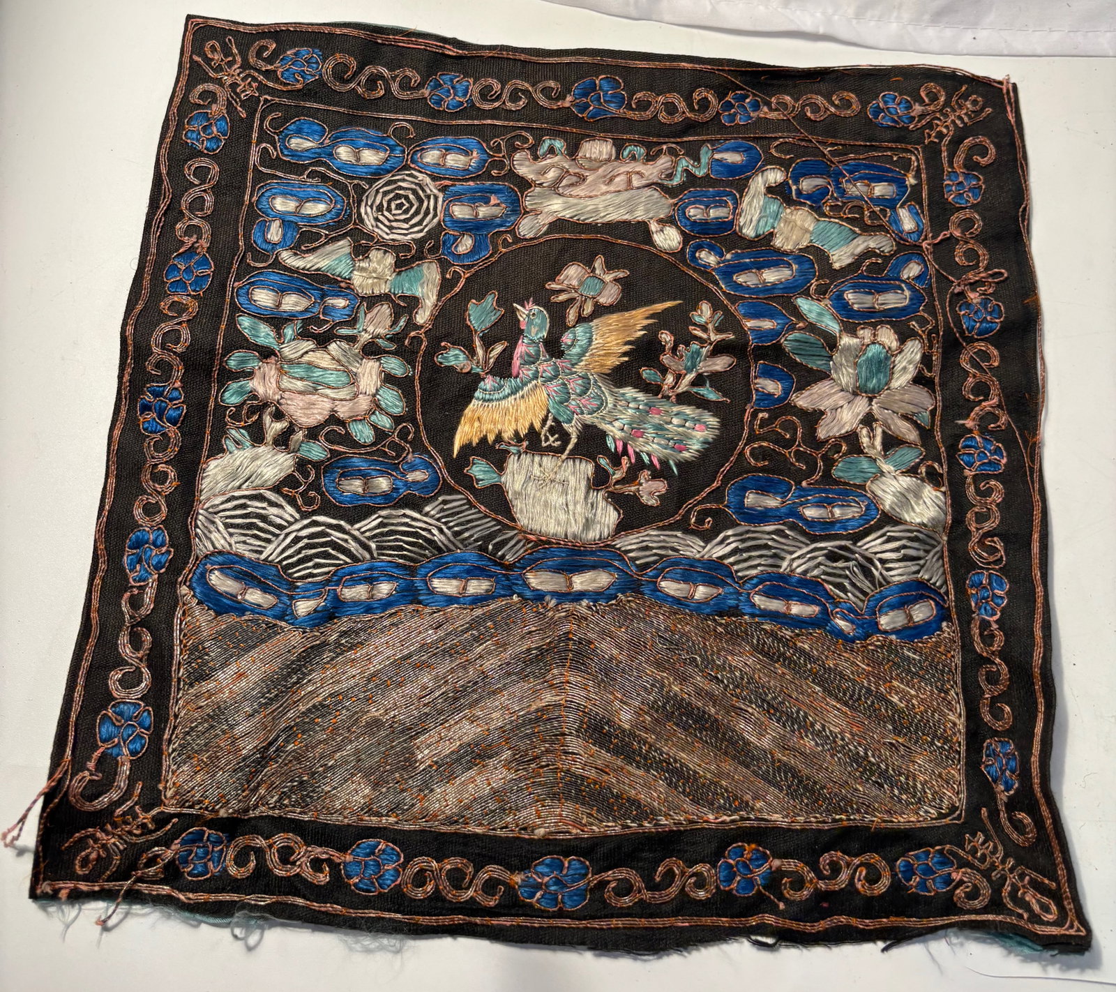 A Chinese silk embroidered rank badge: Qing Dynasty(1644-1912) , These textiles were worn on the front and back of robes by court officials and their wives to signify civil or military status; The featured motif is a phoenix, which typical