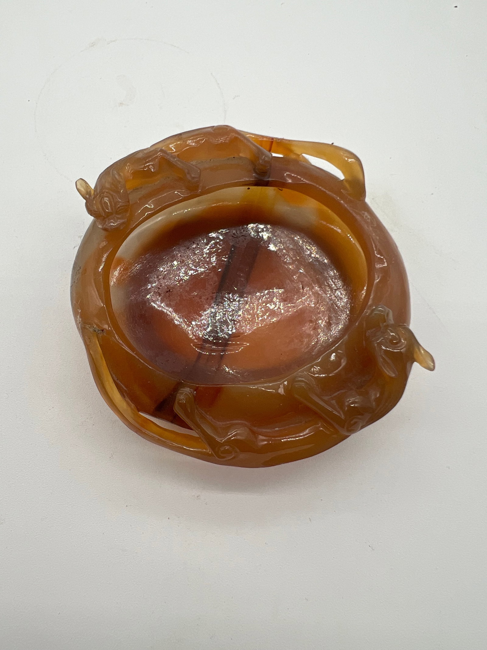 A Chinese hand carved dragon agate water pot: Qing dynasty (1644-1912); The yellow-brown carved agate with two dragons on top.Dimensions? Length: 4 inches; height : 1.5 inches