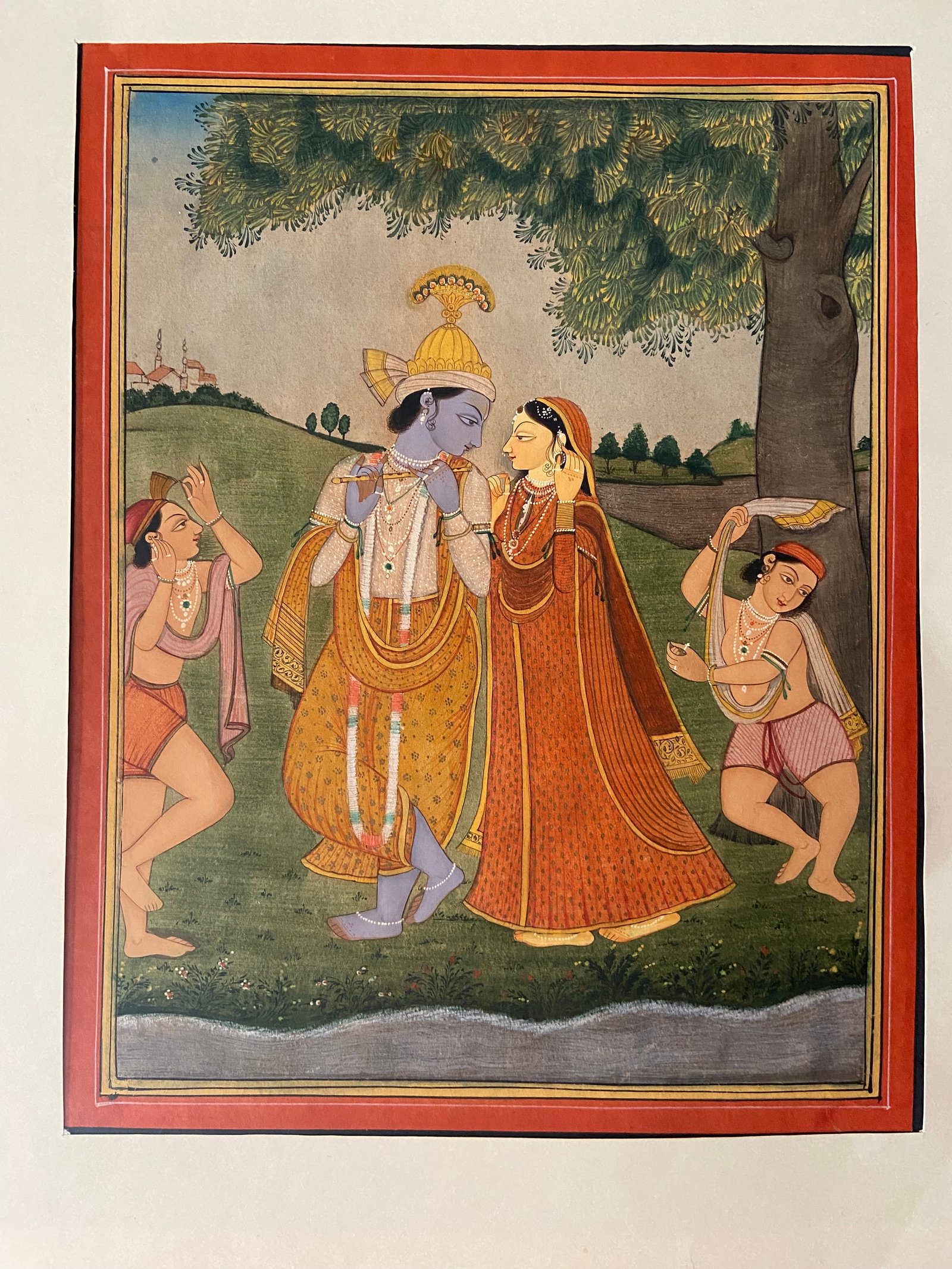 Royal Indian Gouache Miniature of Krishna and Radha with Attendants, Rajasthan: 19th Century; A finely executed royal Indian miniature painting, depicting Lord Krishna and Radha in an intimate moment beneath a tree, accompanied by attendants. Krishna is shown adorned in regal att