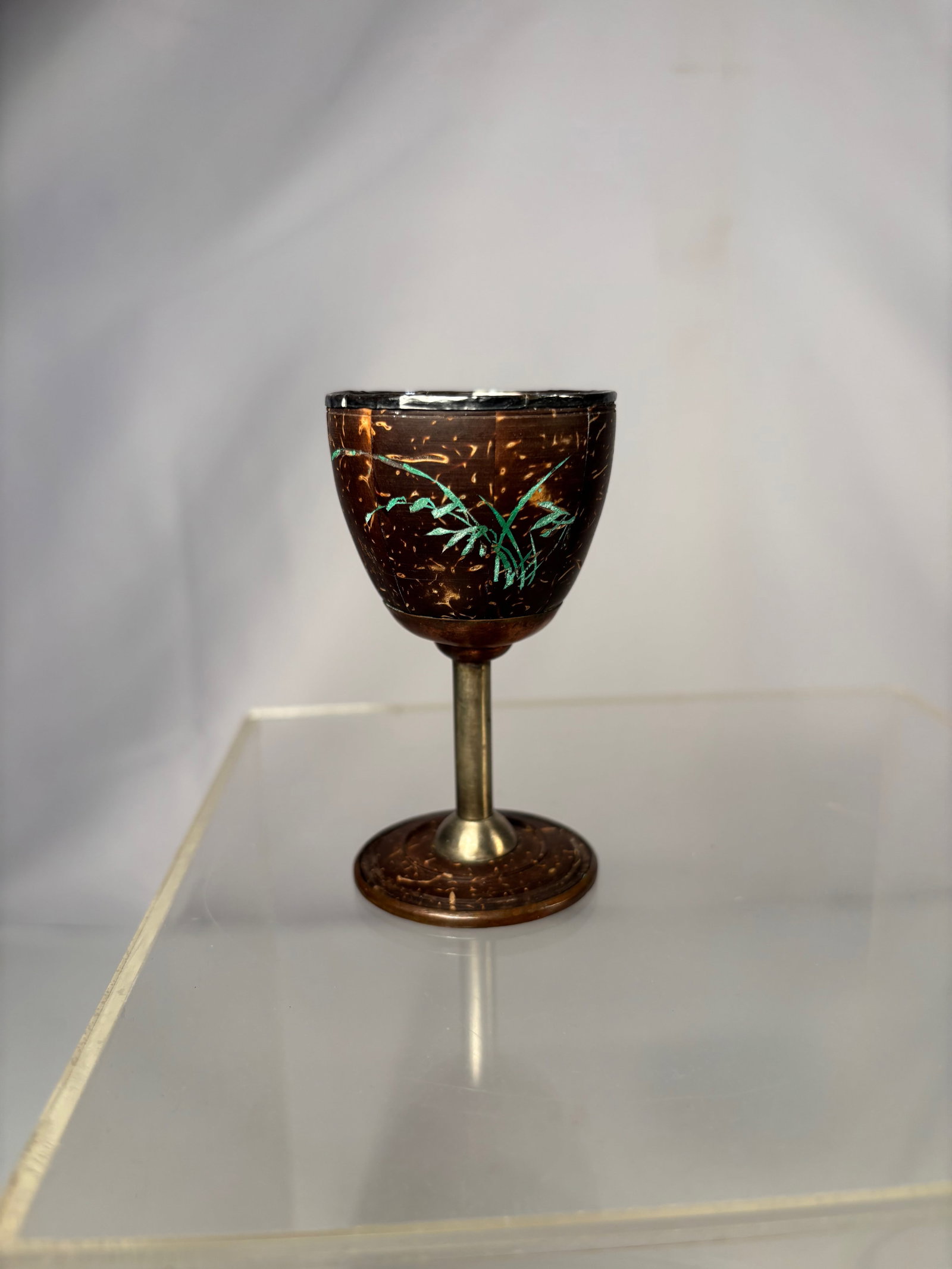 Chinese Silver-Mounted Coconut Shell Goblet with Silver-Lined Interior: Chinese coconut shell goblet featuring a silver-lined interior and a silver-mounted rim, raised on a non-silver stem and foot. The natural coconut shell exterior is carved and decorated with engraved 