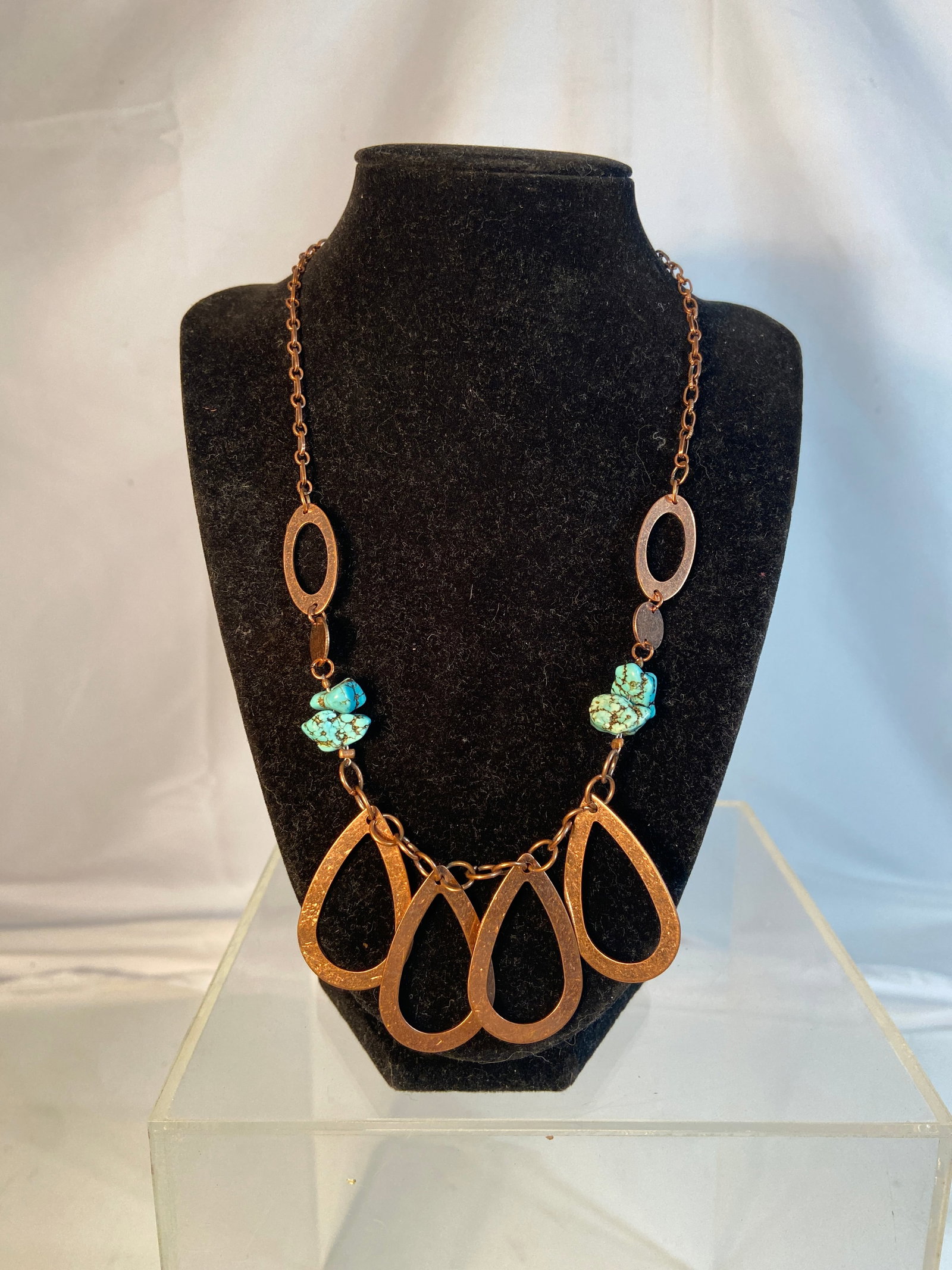Vintage Southwestern Style Turquoise Tone Statement Necklace: Vintage Southwestern style statement necklace featuring turquoise-tone nugget accents and large copper-tone openwork teardrop pendants. Suspended from a linked copper-tone chain with toggle clasp clos