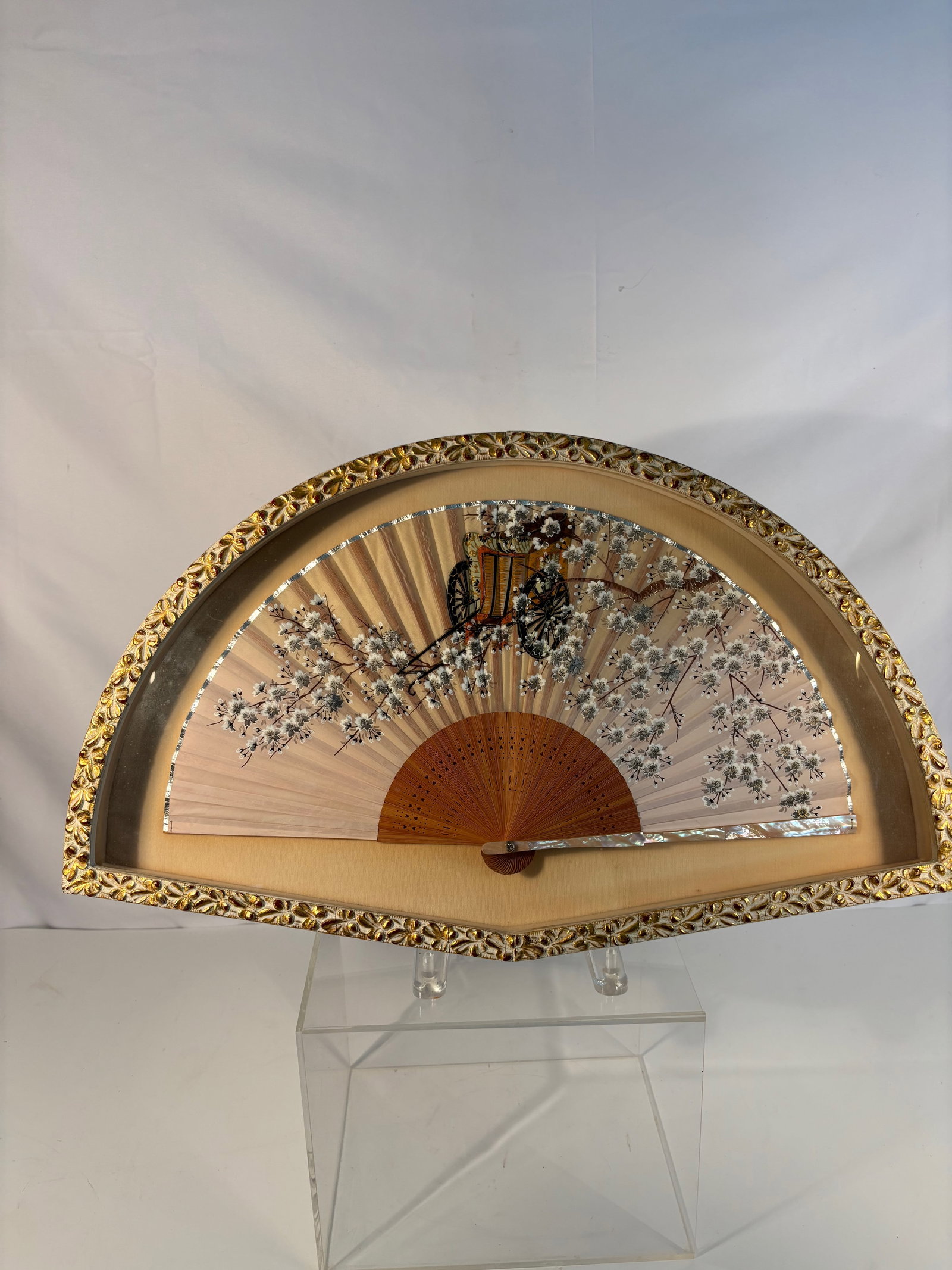 A Japanese Framed Fan with Blossoms & Ox Cart, Mother-of-Pearl Inlay: A Japanese Meiji period folding fan, finely hand-painted with blossoming cherry branches and an ox-drawn carriage, a motif associated with imperial court life. The blossoms and borders are delicately 