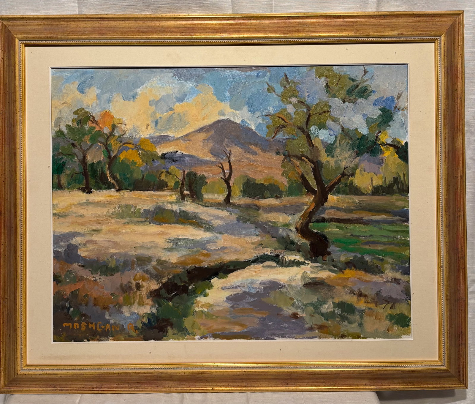 Moshgan Rezania Signed Original Oil Landscape Painting: An original signed oil painting by Moshgan Rezania, depicting a luminous mountain landscape with flowering trees, meadow, and distant hills. Painted in the artist’s expressive plein-air style, the c