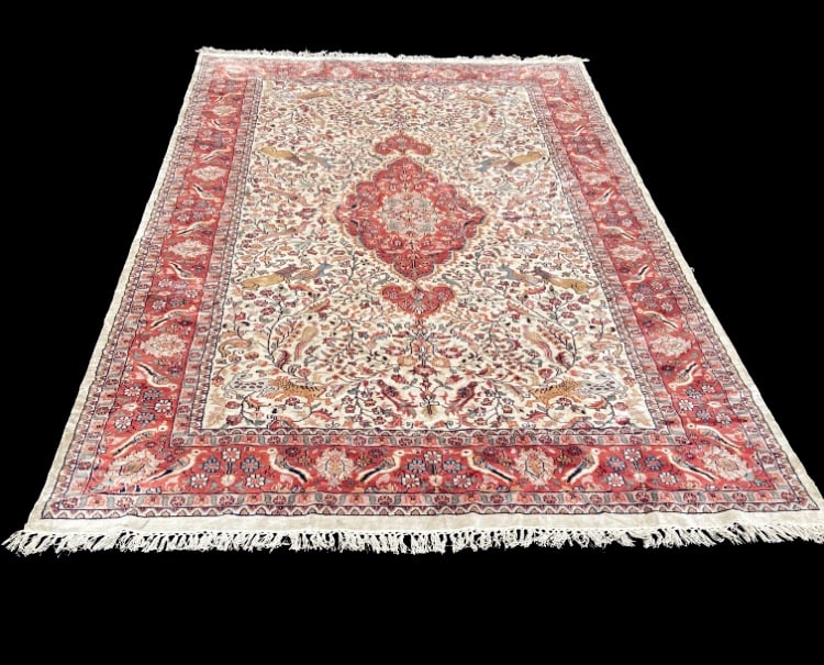 Persian Tabriz Style Wool & Silk Hunting Scene Rug w/ Animal Motifs: A finely woven Persian Tabriz style rug featuring a richly detailed hunting scene design with various animals, birds, and floral motifs throughout an ivory field. The composition is centered by a trad