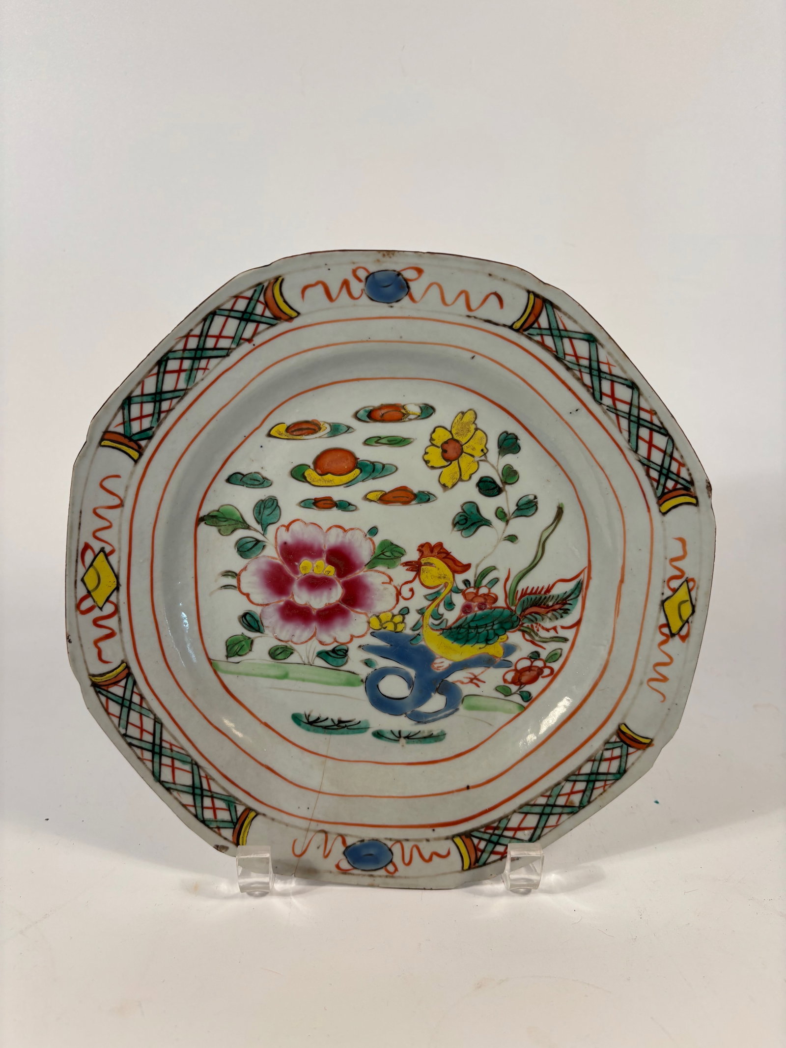 A Chinese Famille Verte porcelain plate: 17th -18th century; Shape: Octagonal or barbed-rim form, often seen in Kangxi export wares. Dimensions?Length: 9.25 inches.